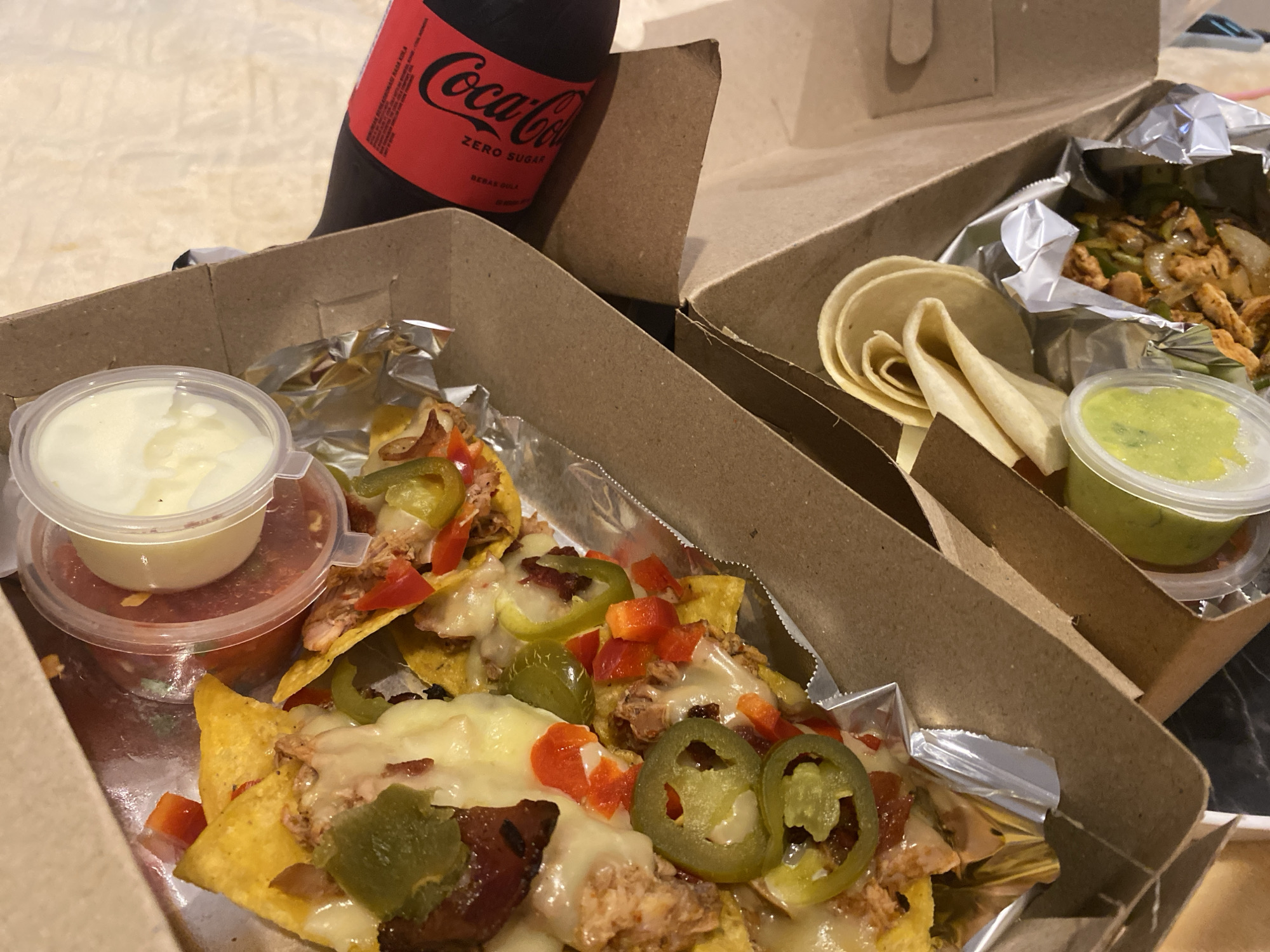 Indonesian diner documents takeout nacho meal with beverages