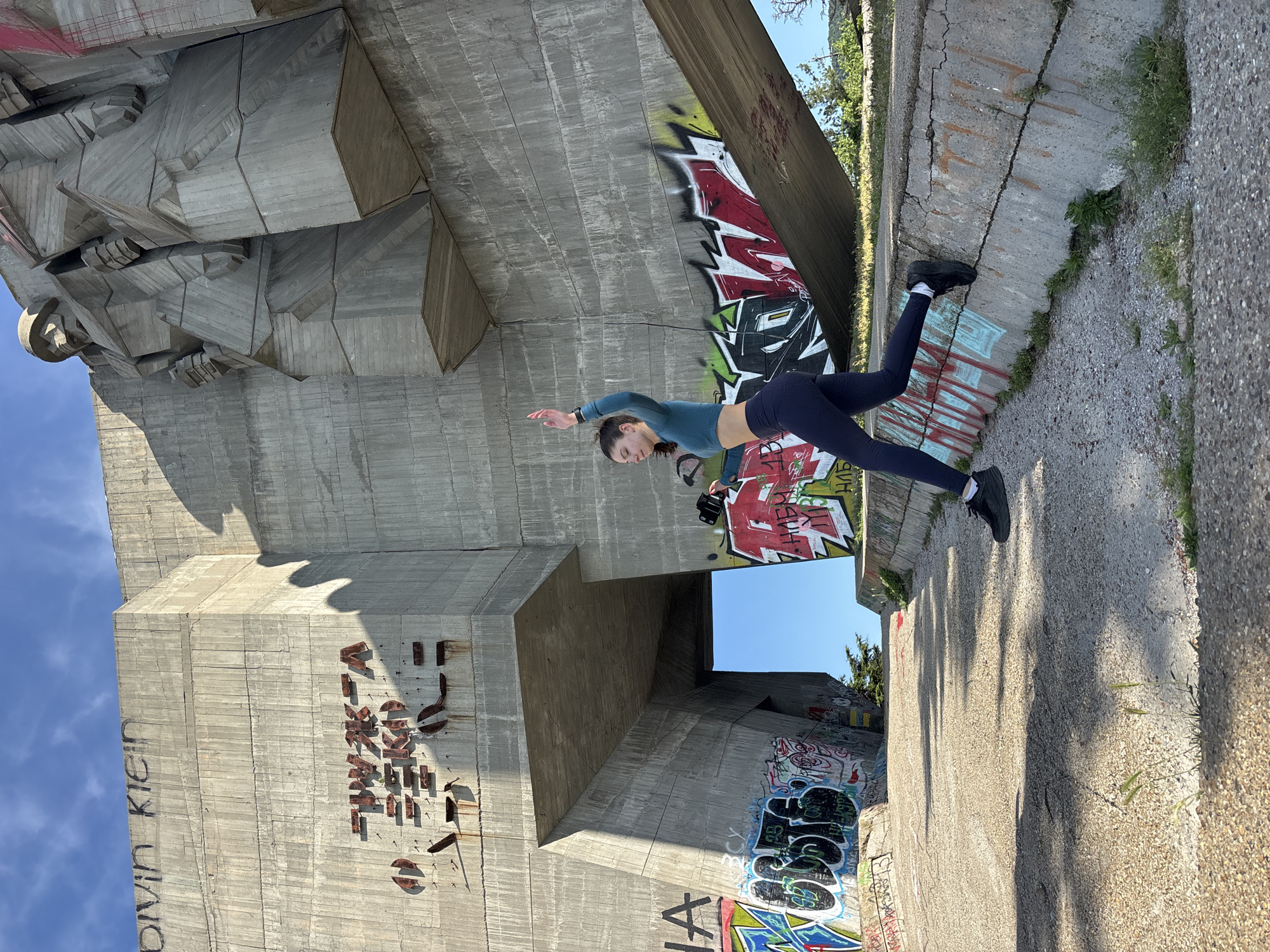 Woman performs fitness routine near monuments in Varna, Bulgaria