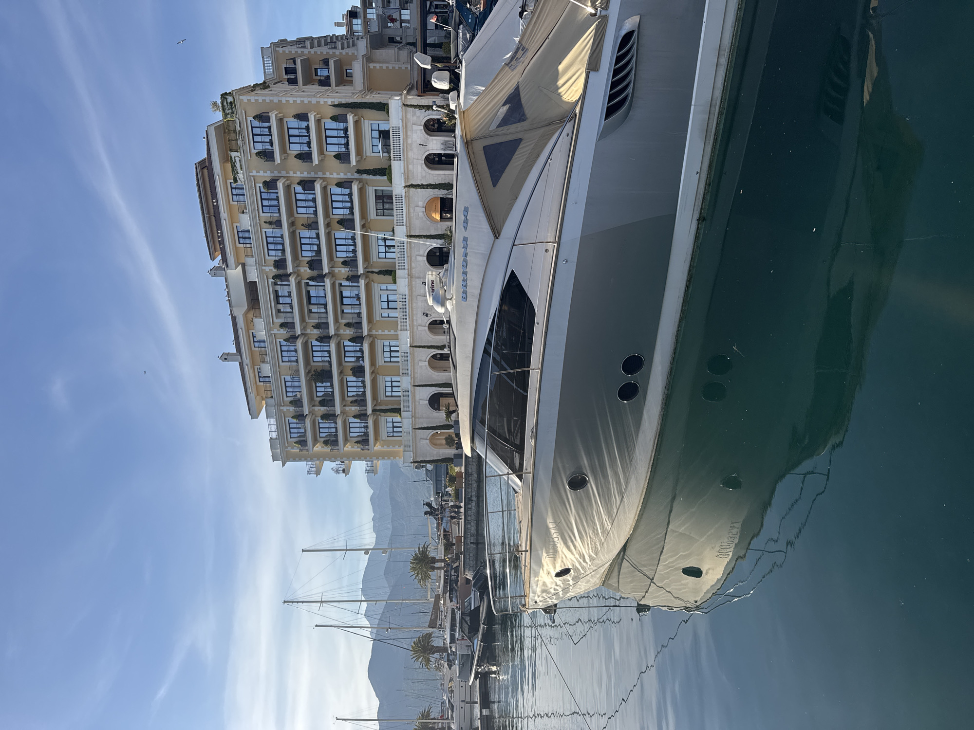 Luxury yachts docked at Tivat marina on sunny afternoon
