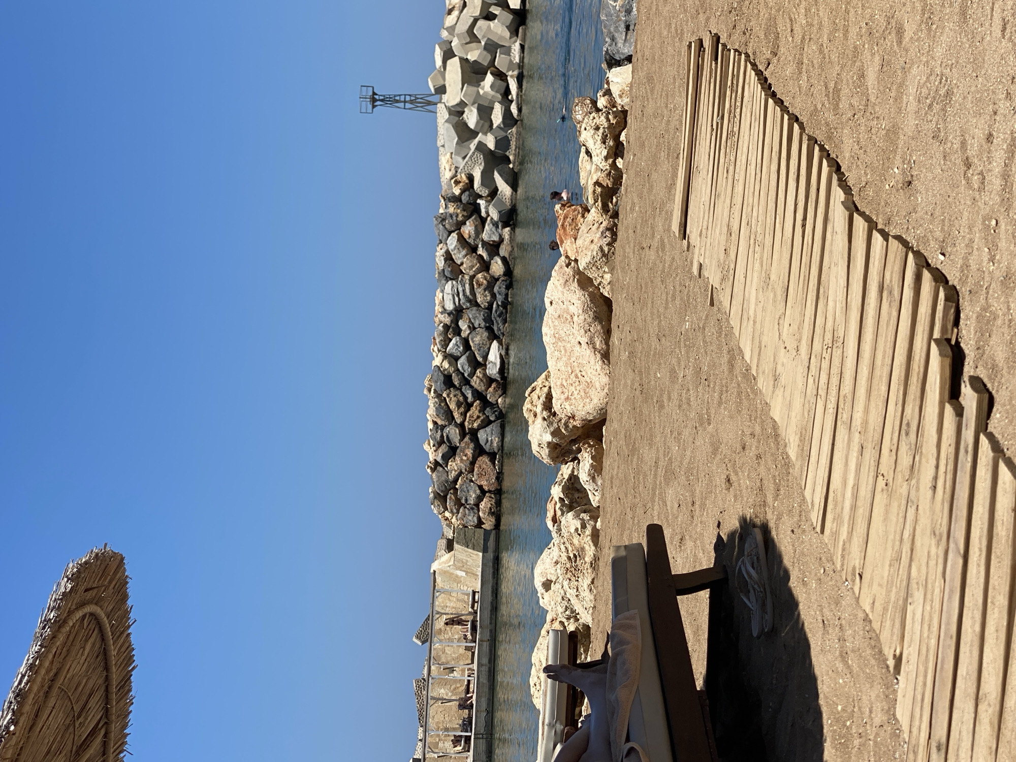 Sunny day on the wooden boardwalk at Panormos beach