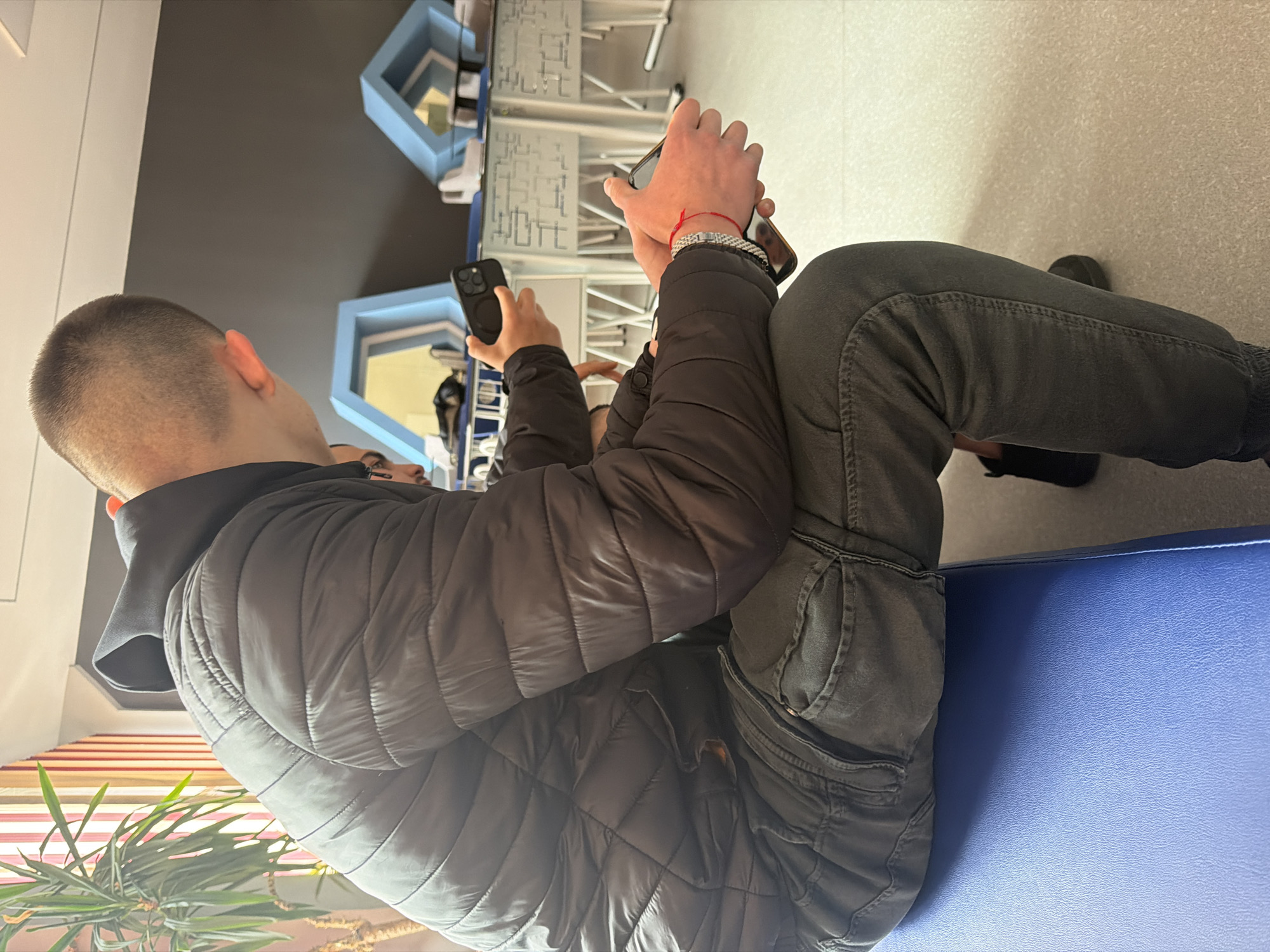 People gather indoors with smartphones in General Toshevo