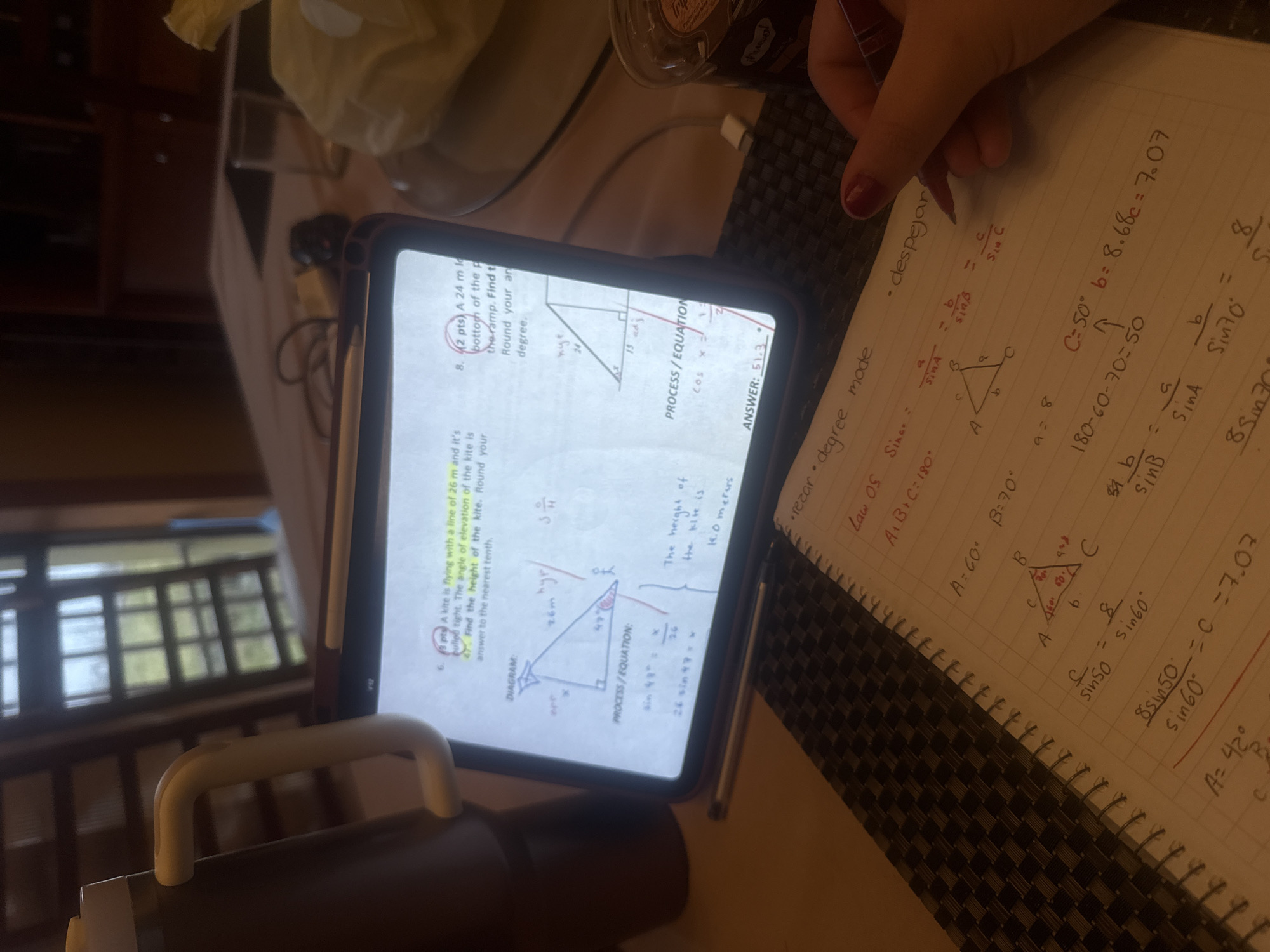 Student tackles trigonometry homework with chocolate dessert nearby