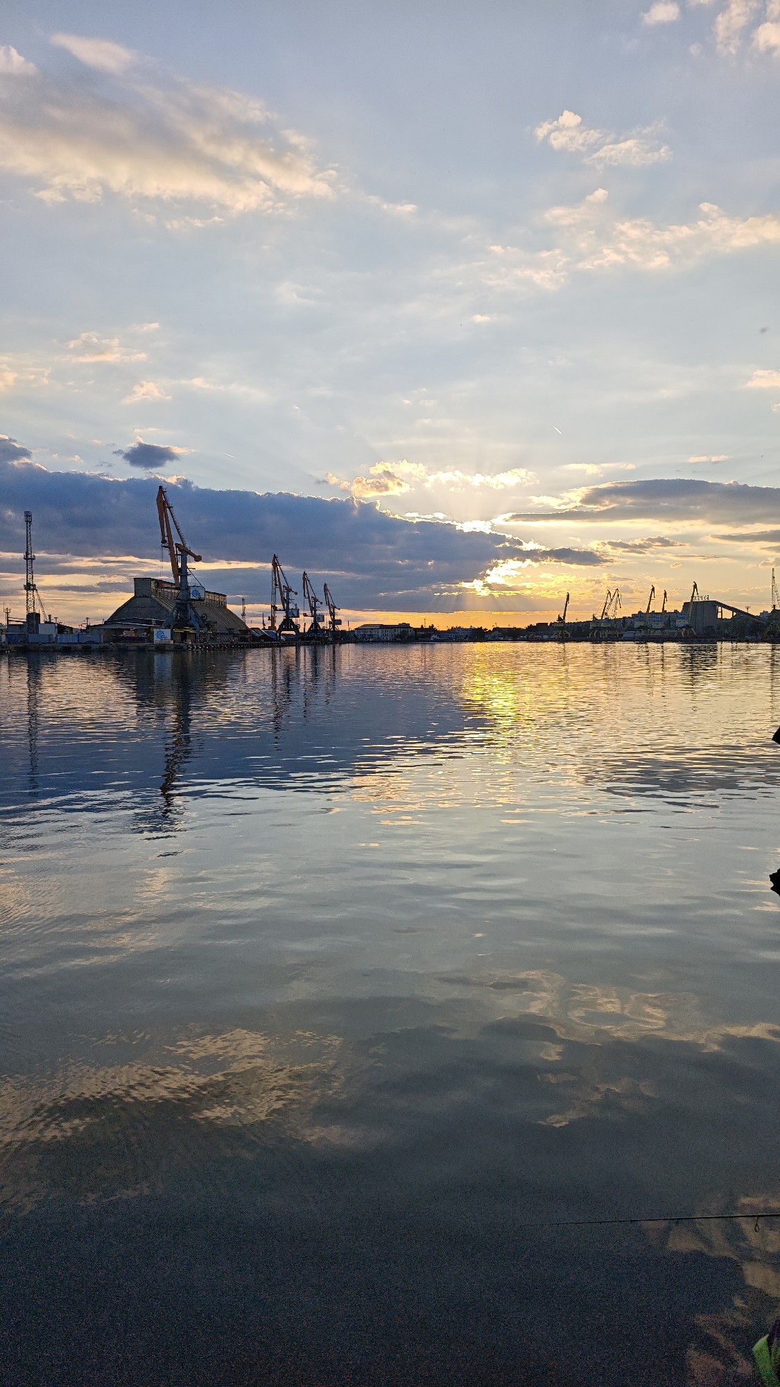 Evening fishing session at Burgas harbor during sunset