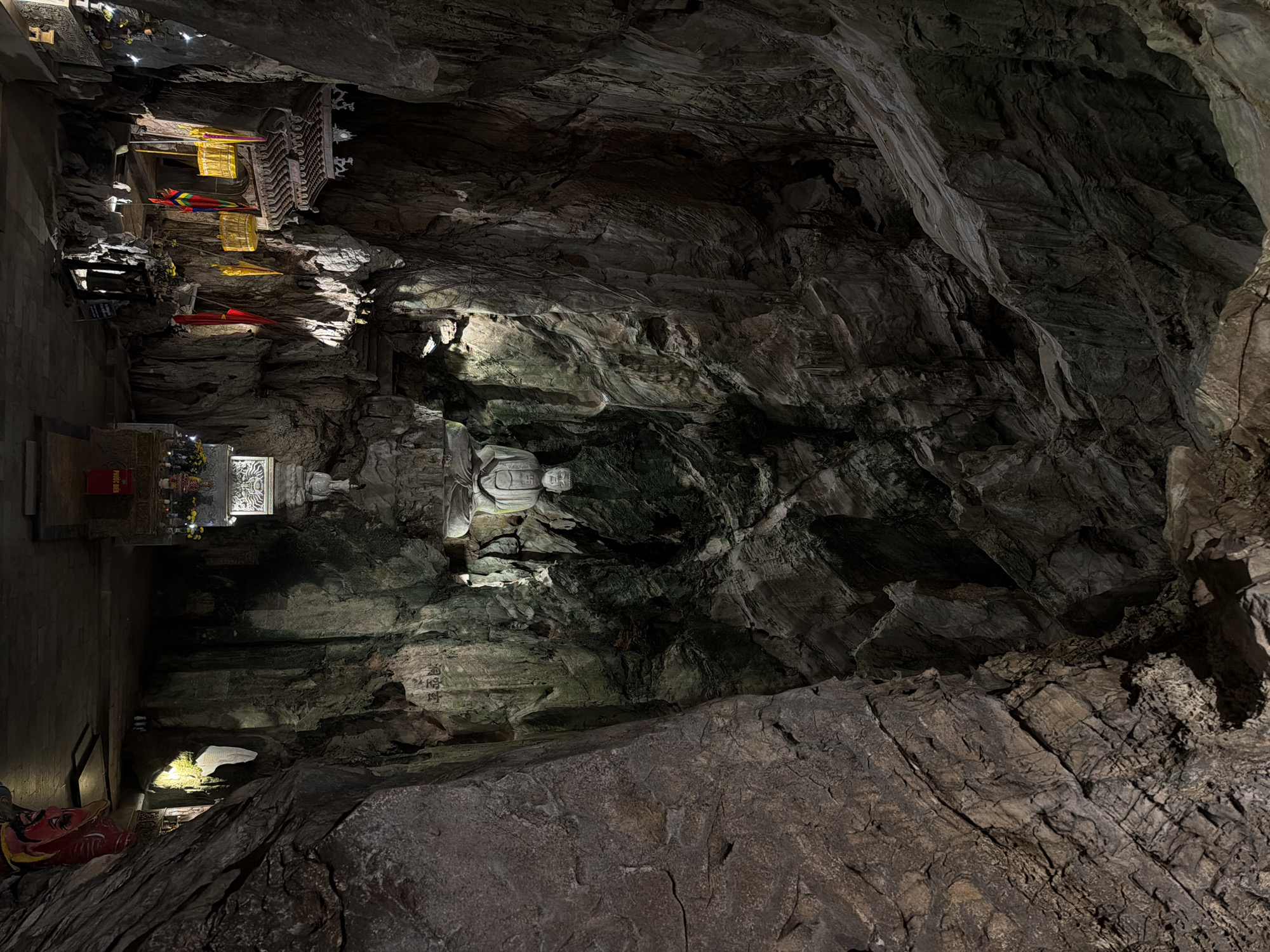 Cave temple with illuminated Buddha statue documented in Đà Nẵng