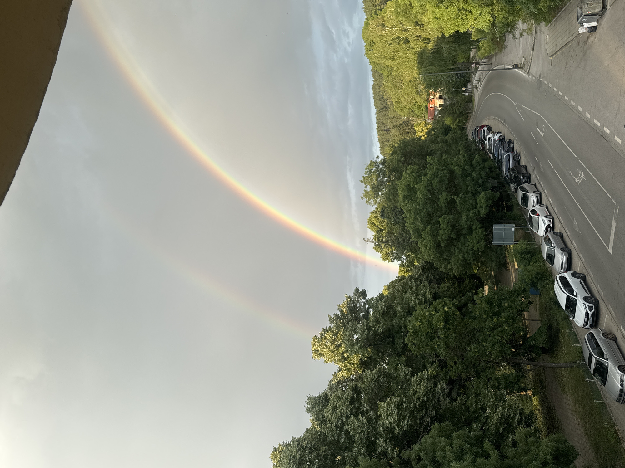 Double rainbow over Bankya's tree-lined streets after rain