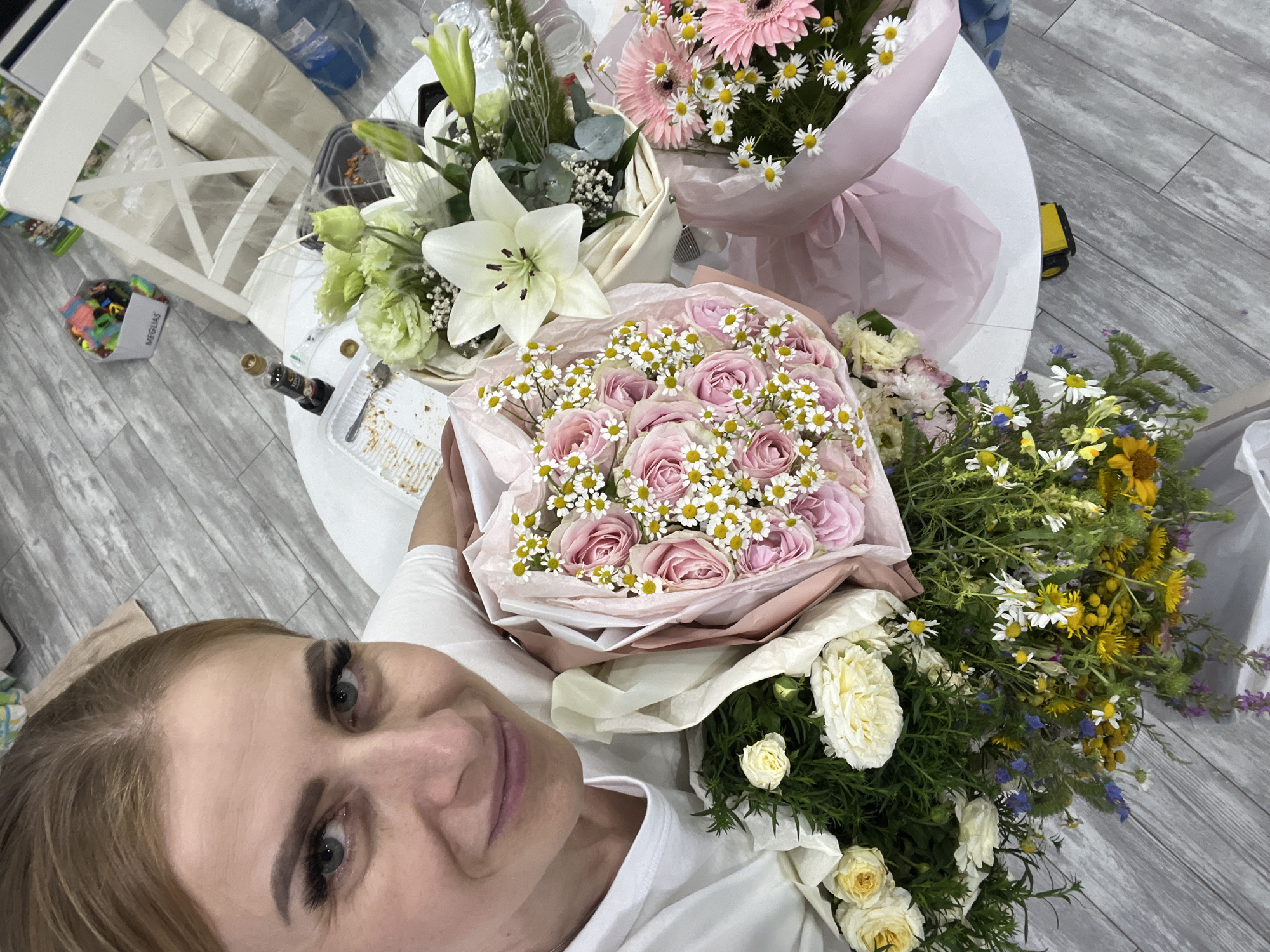 Posing with bouquets indoors in Bataysk, Russia