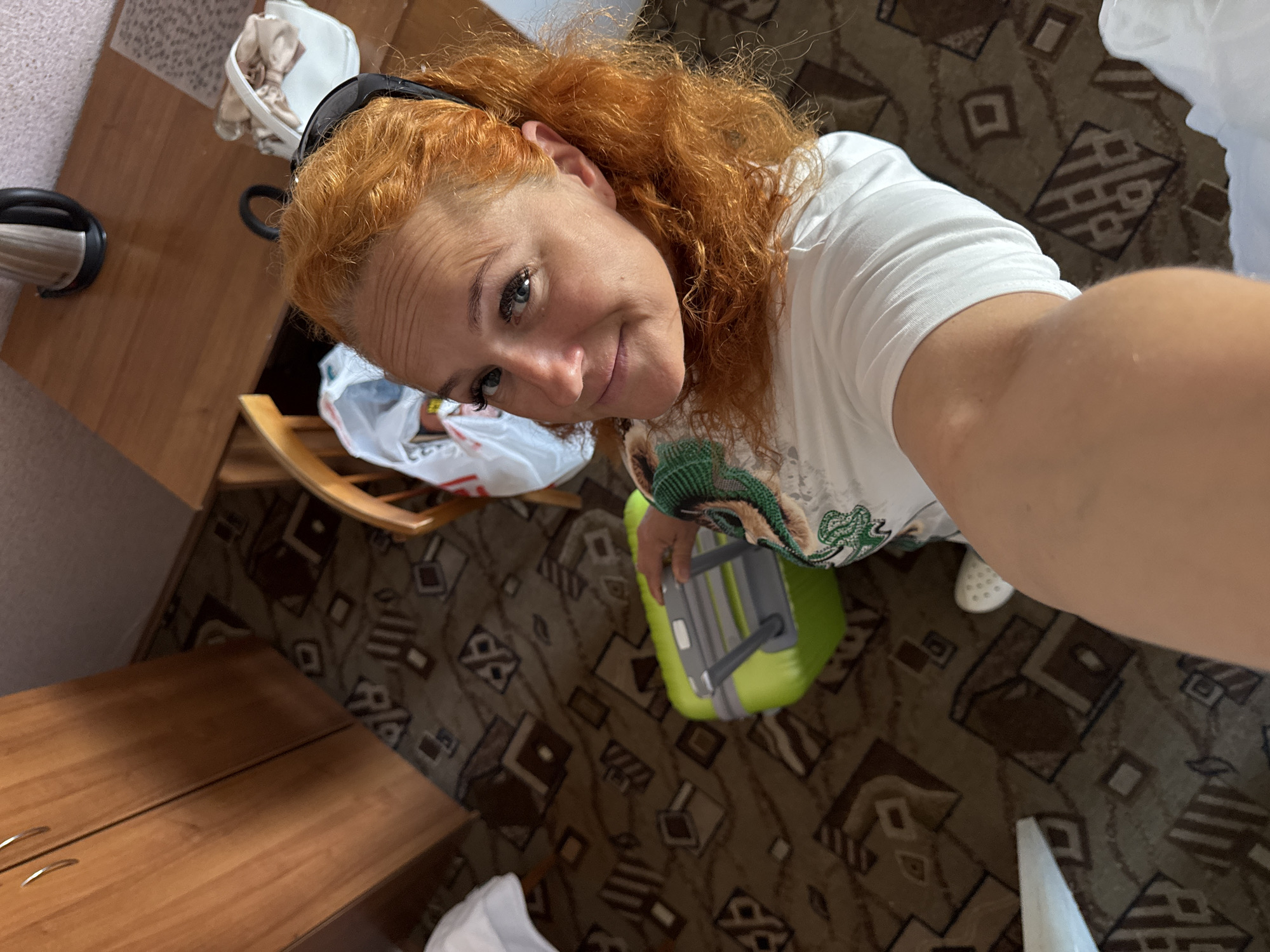 Checking out of a Kazan hotel, green suitcase in tow
