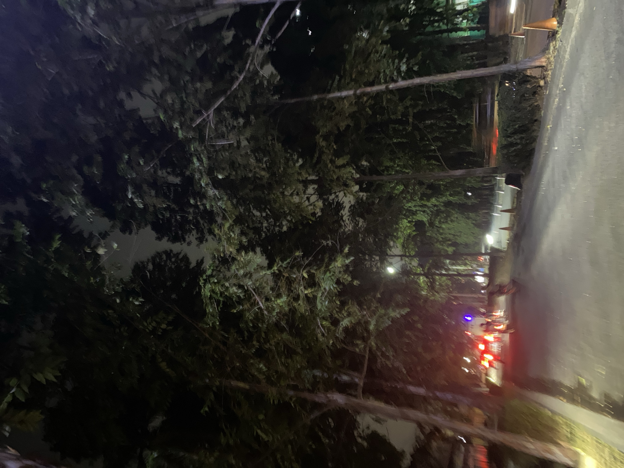 Tangerang streets at night: traffic, wet roads, Big Ben replica