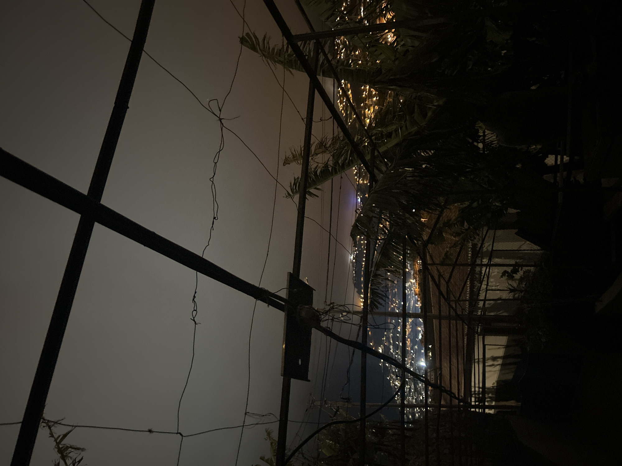 Foggy night captured through metal framework in Câmara de Lobos