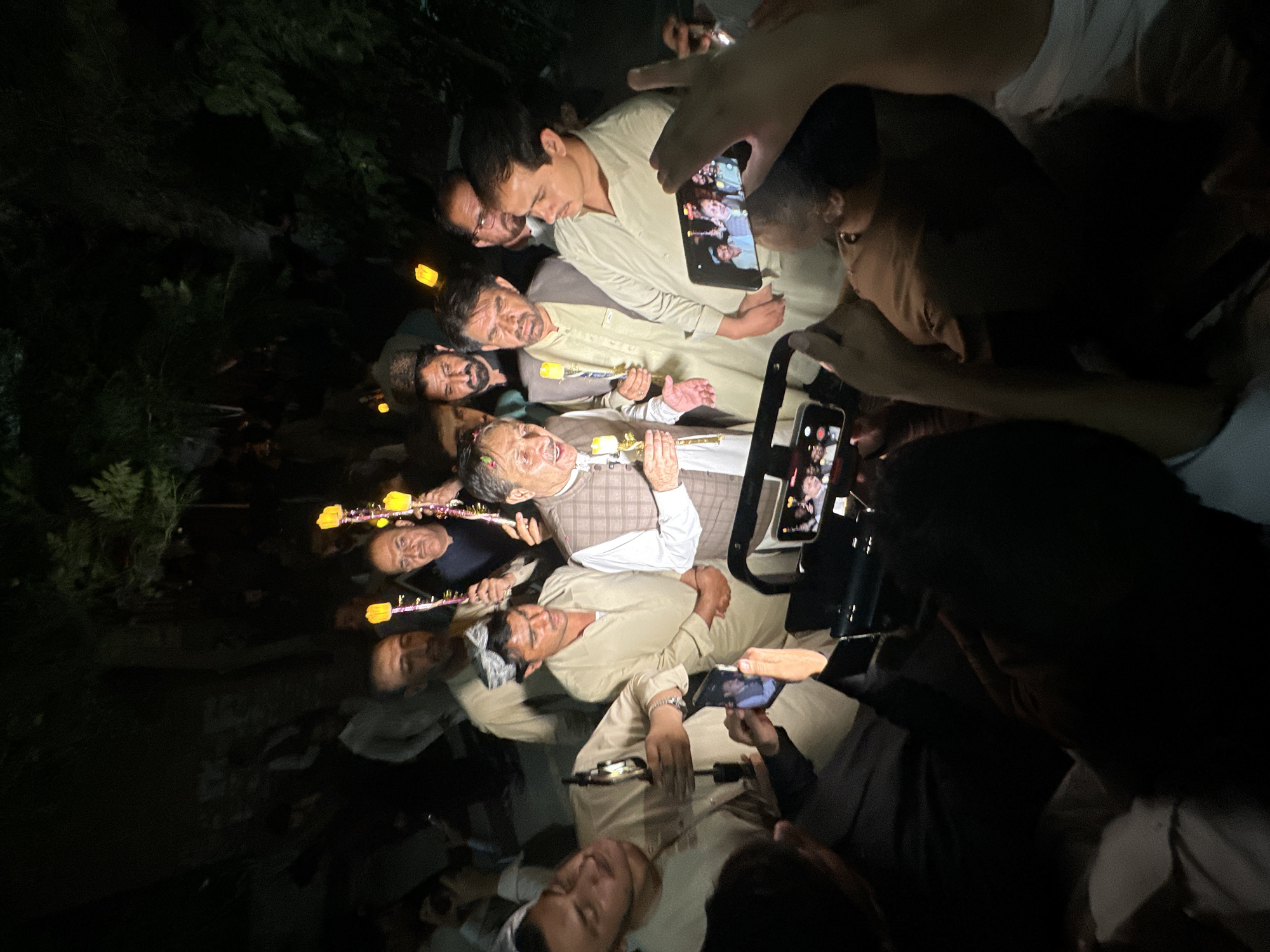 Candlelight vigil with portrait display in Quetta at night