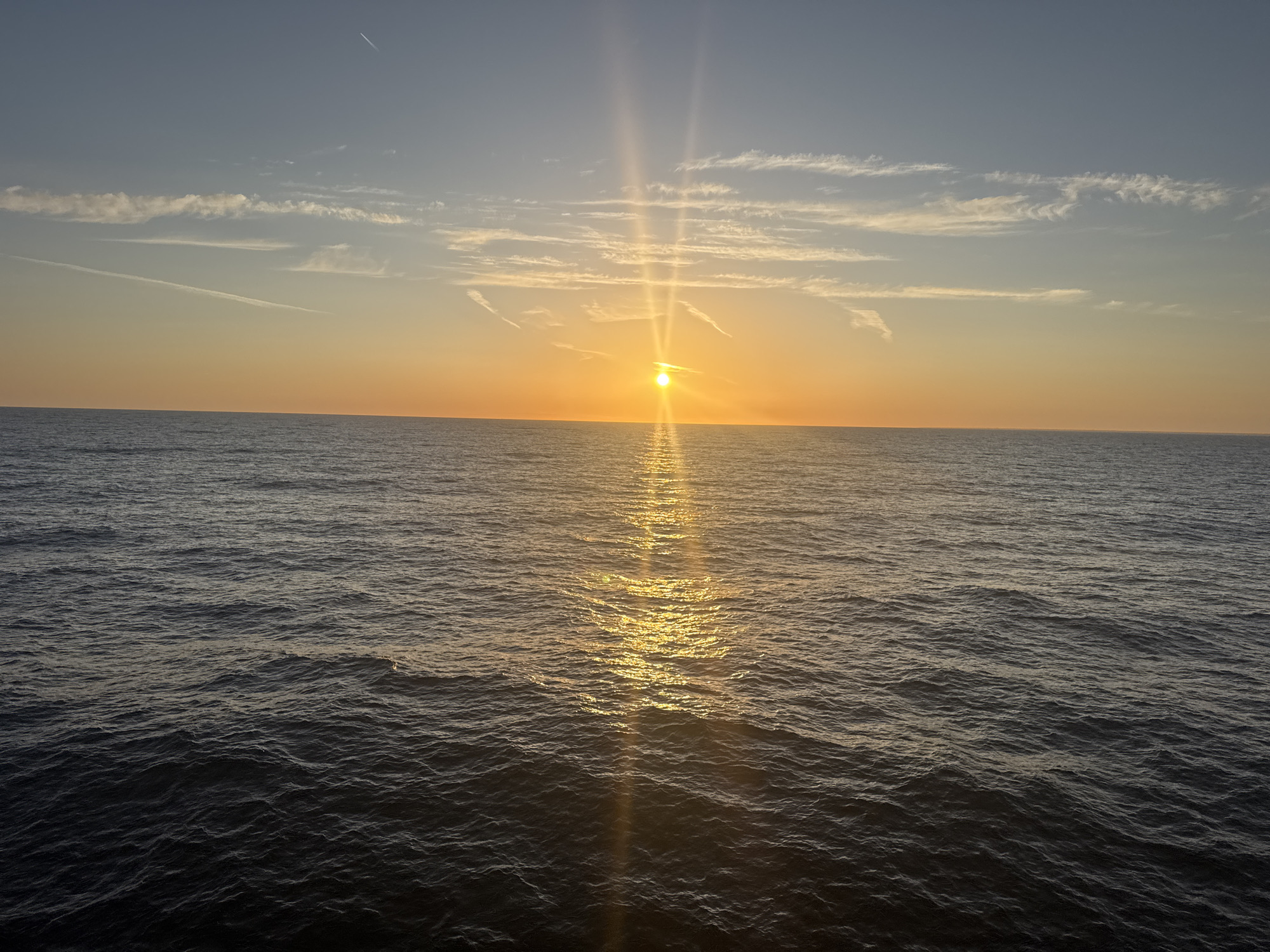 Drone glides over Baltic coastal waters at golden hour