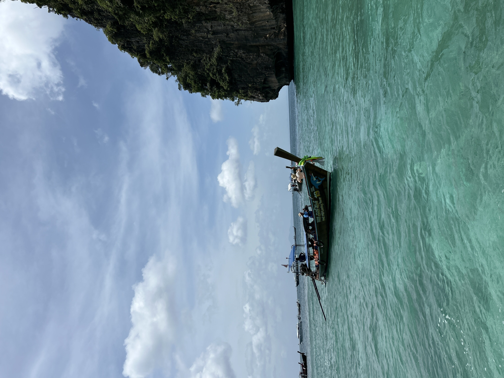 Boat traffic through Ao Nang's limestone cliff channels