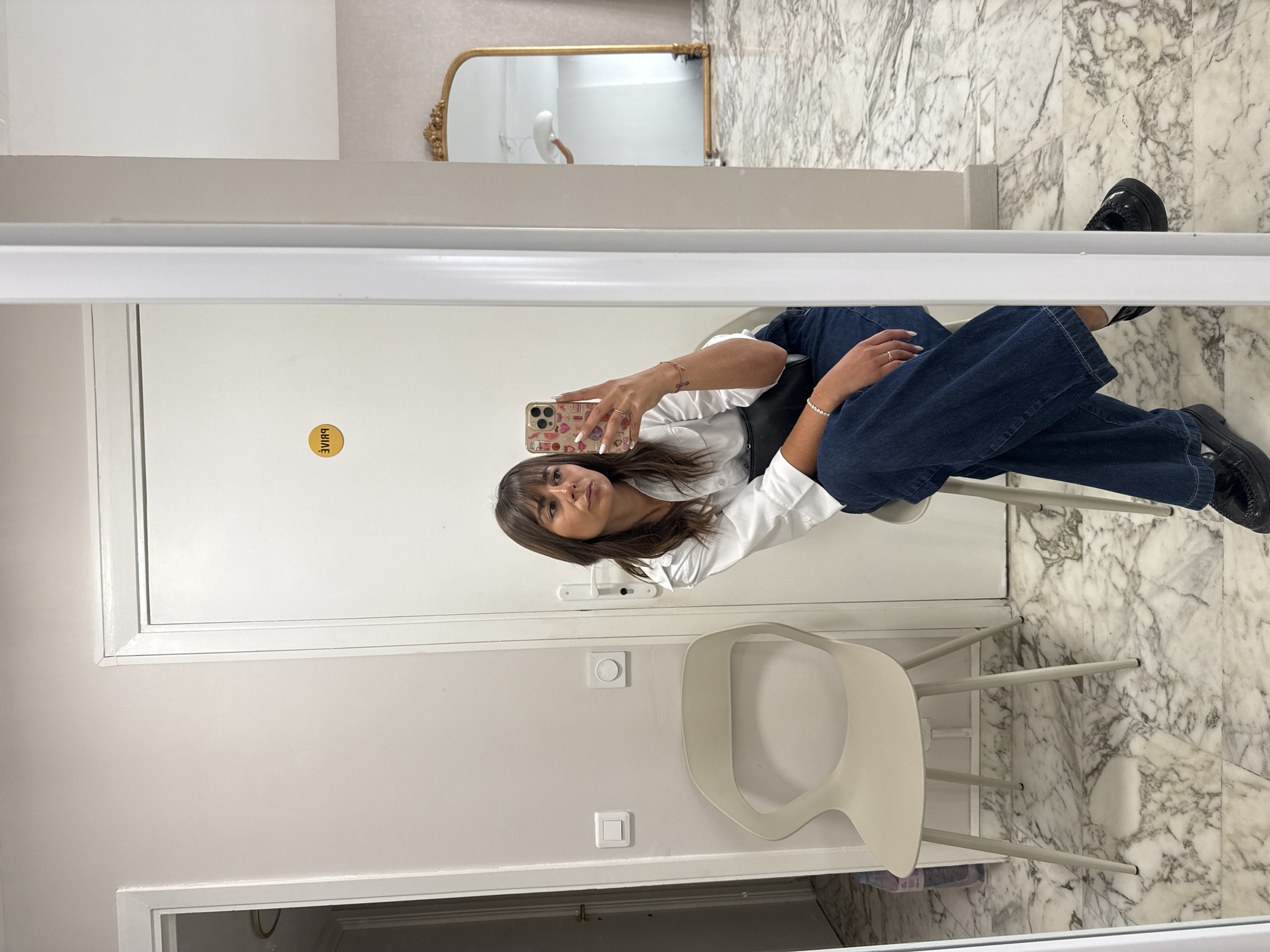 Woman takes selfie in white chair, Cannes France
