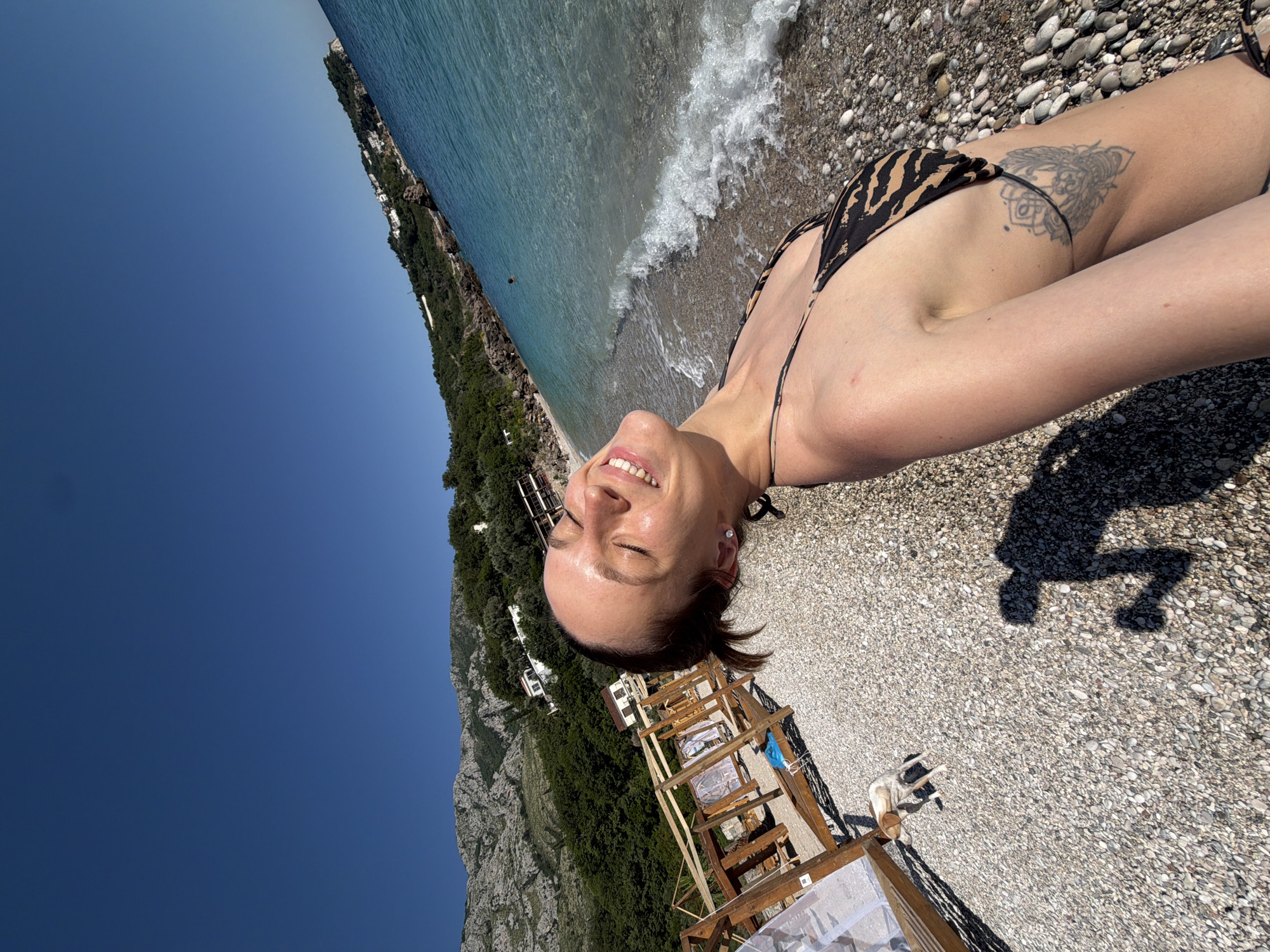 Woman sunbathes on Reževići beach in Montenegro