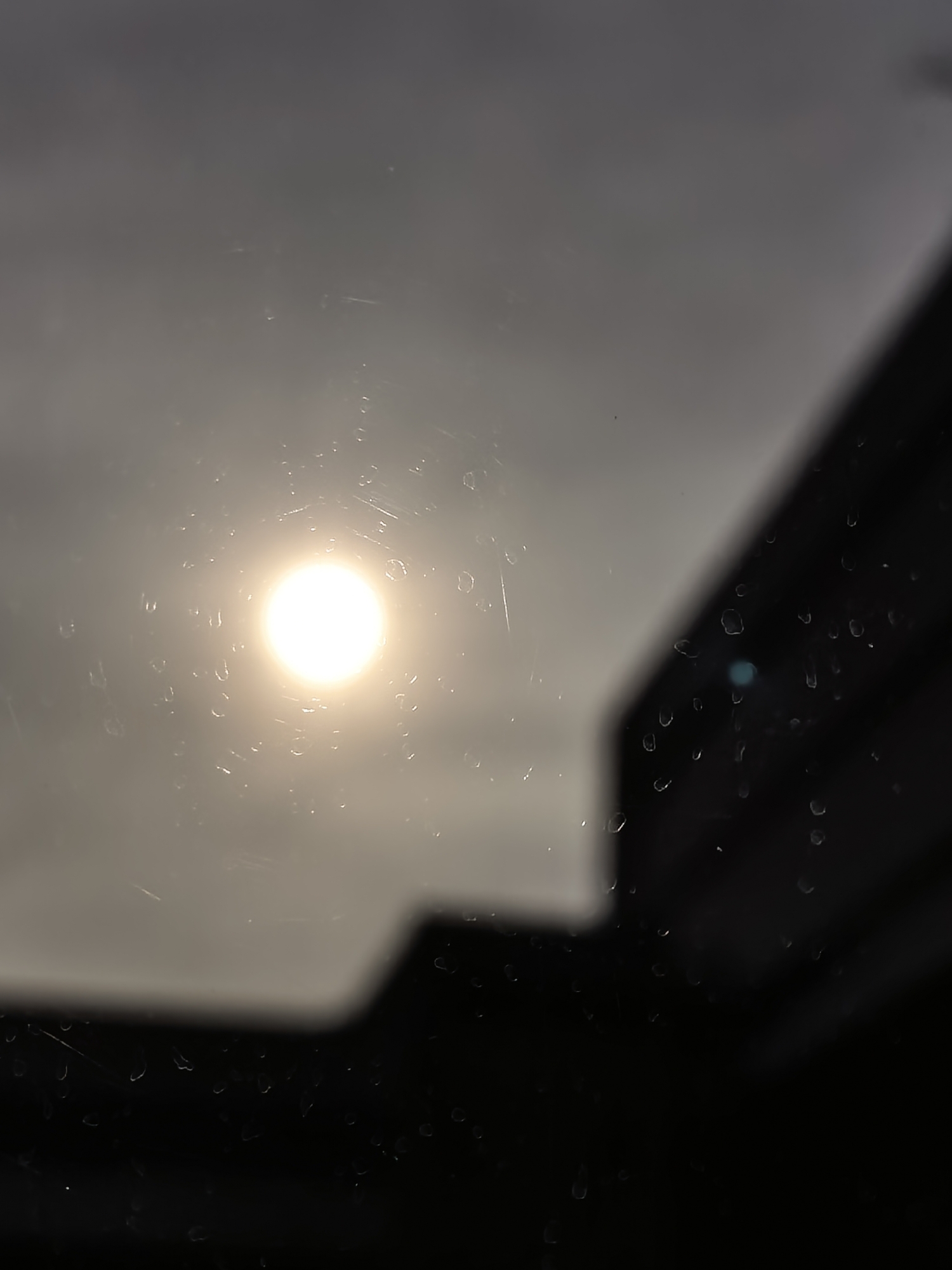 Morning street scenes captured through wet glass, Bulgarian vehicle spotted