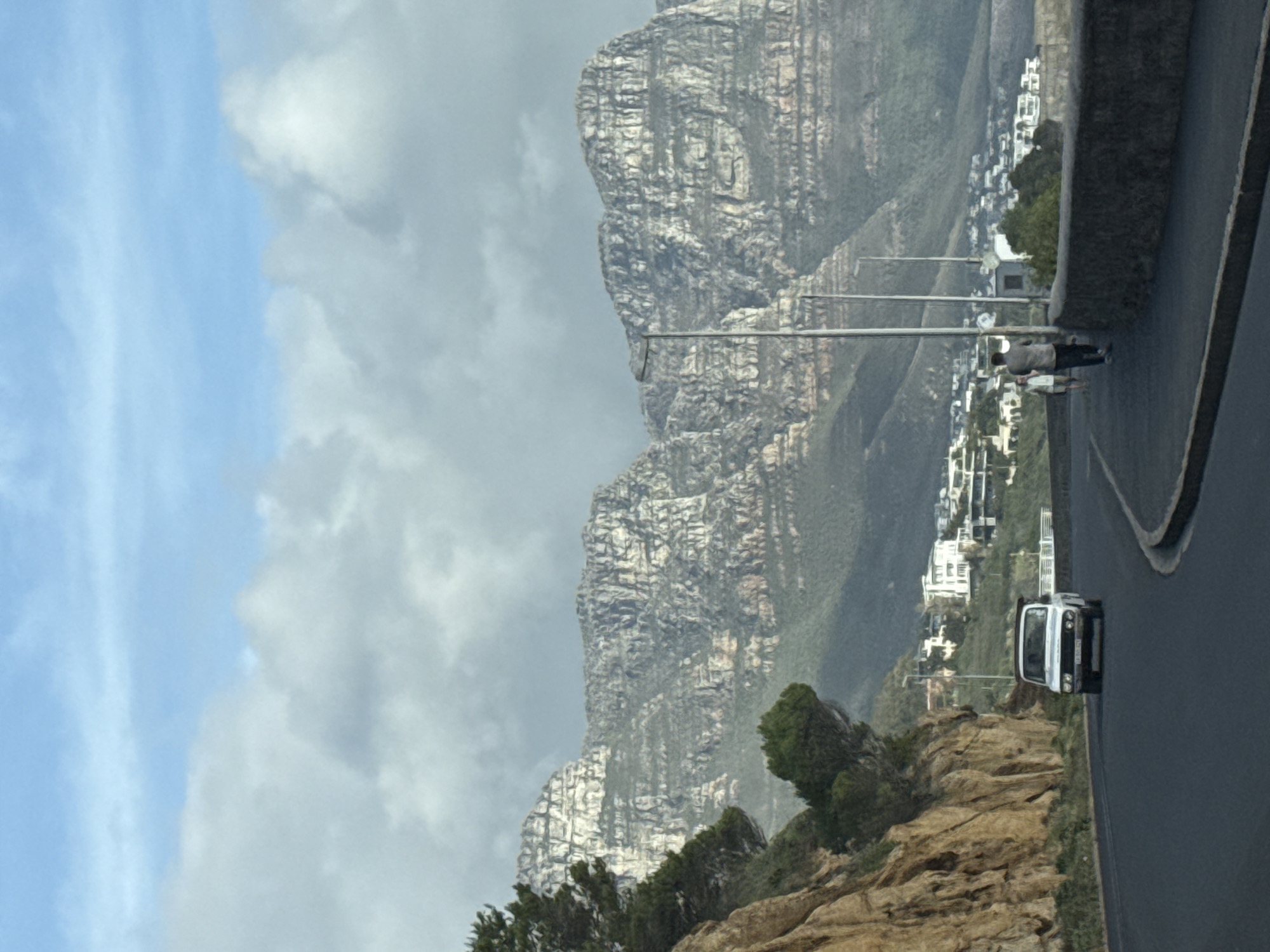 Cape Town roadside views feature cloud-shrouded Table Mountain