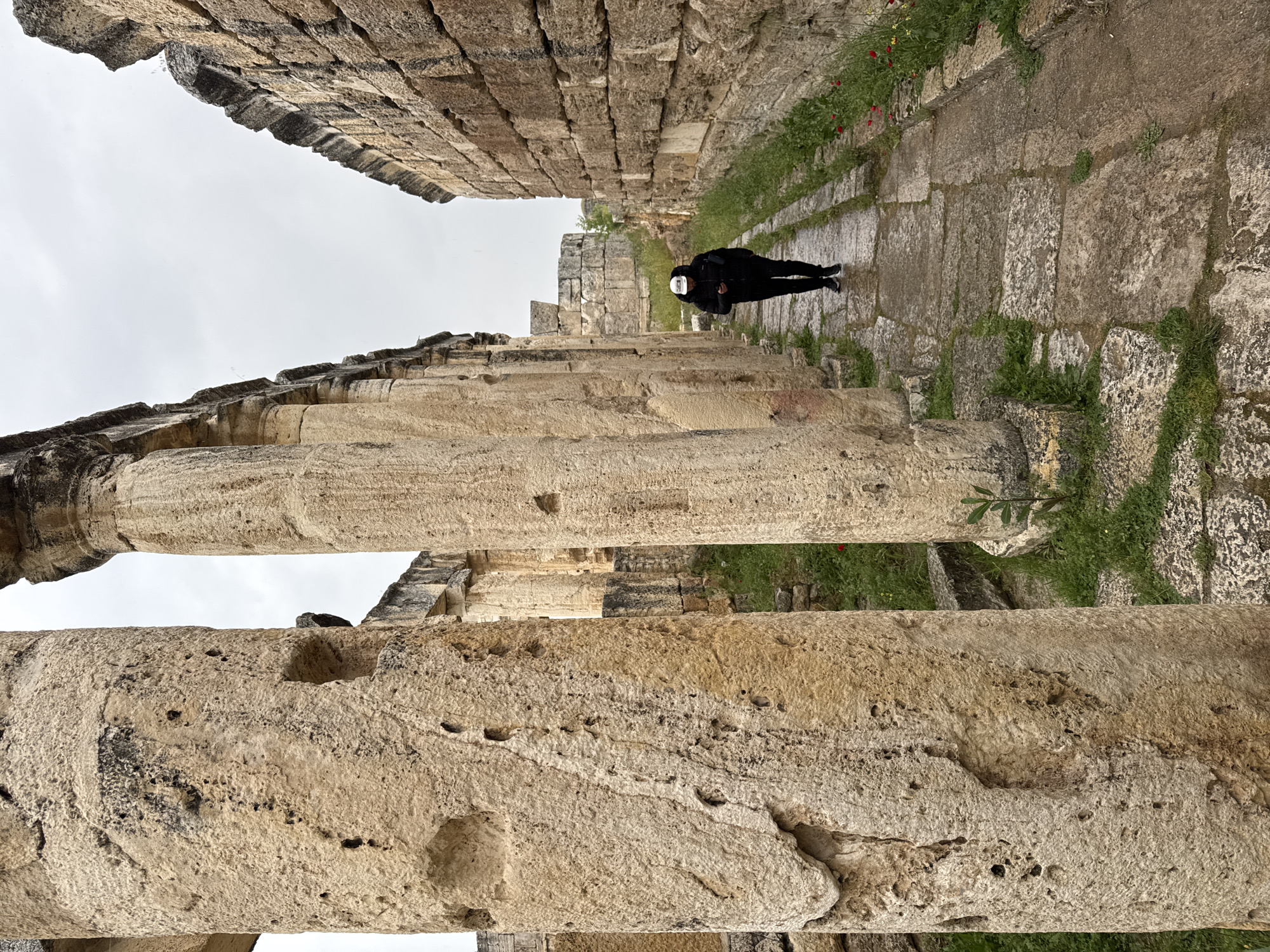 Tourist documents ancient Hierapolis ruins during afternoon visit to Pamukkale