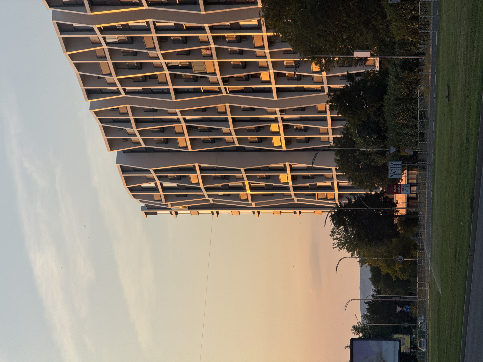 Burgas evening: angular architecture, a passing flight, dusk streets