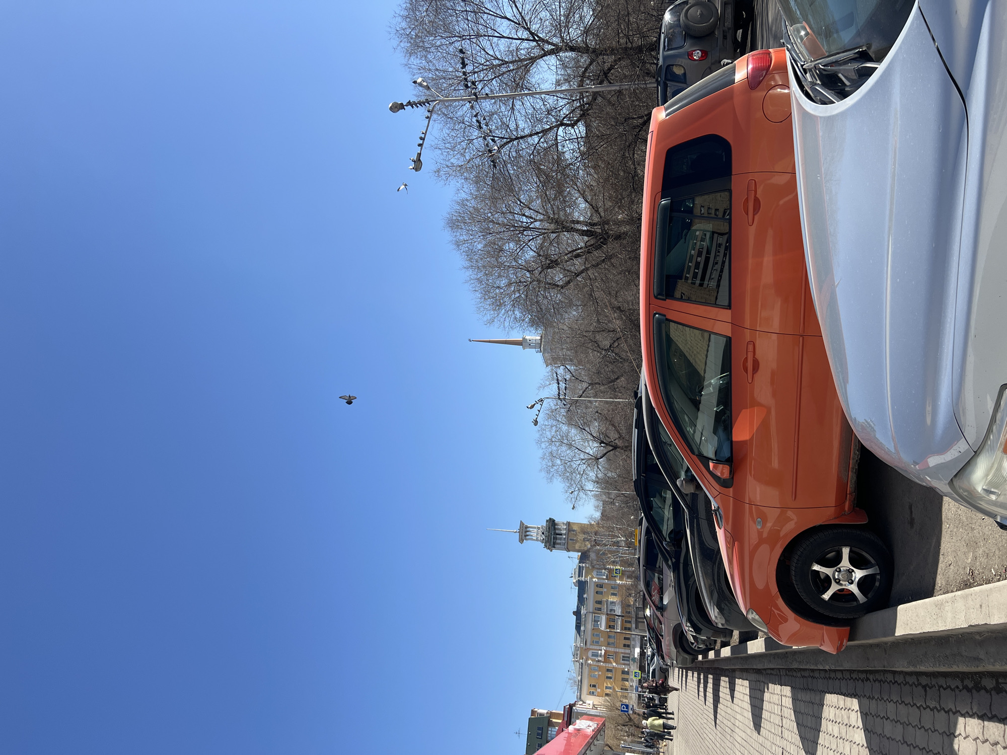Morning street scene shows parked cars in Krasnoyarsk