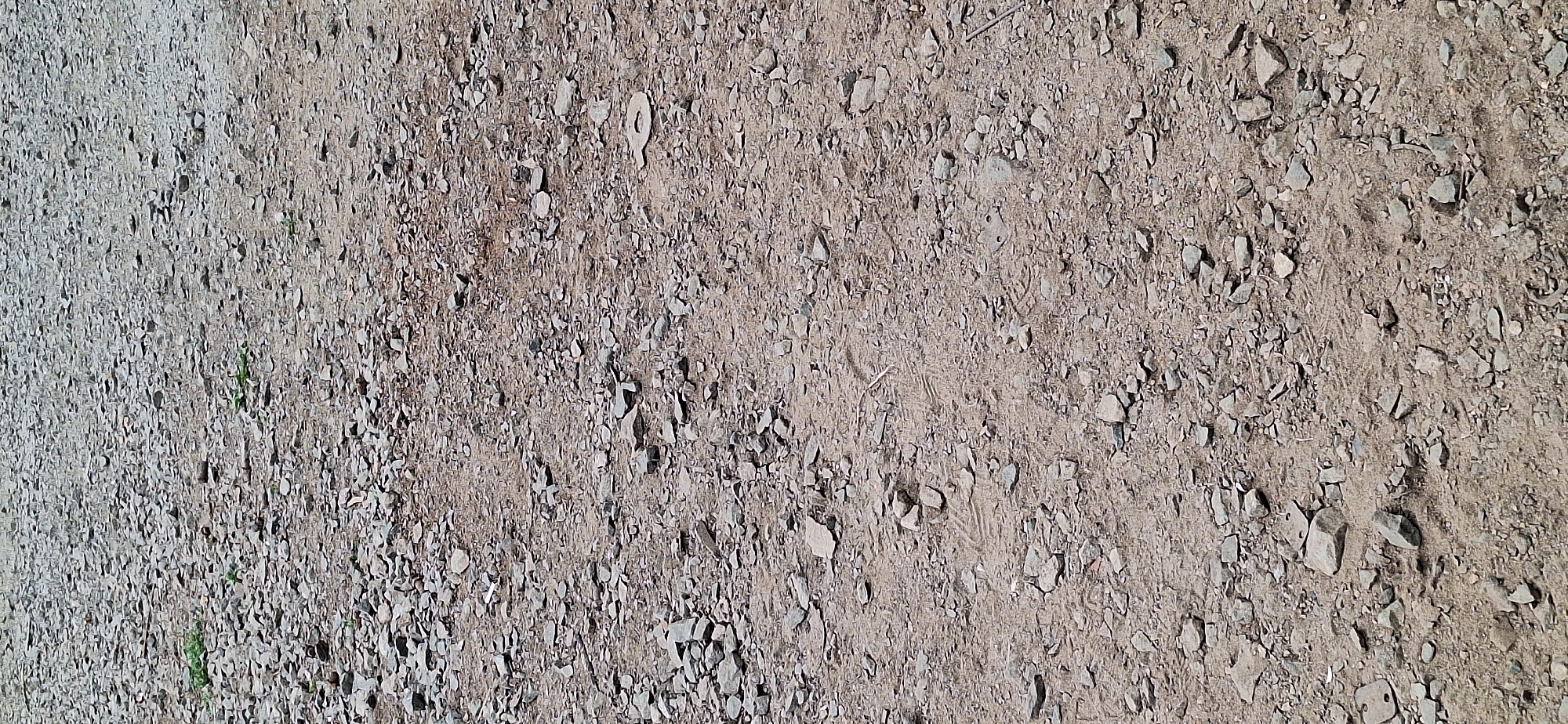 Gravel ground and a parked red cargo tricycle in Nakhodka