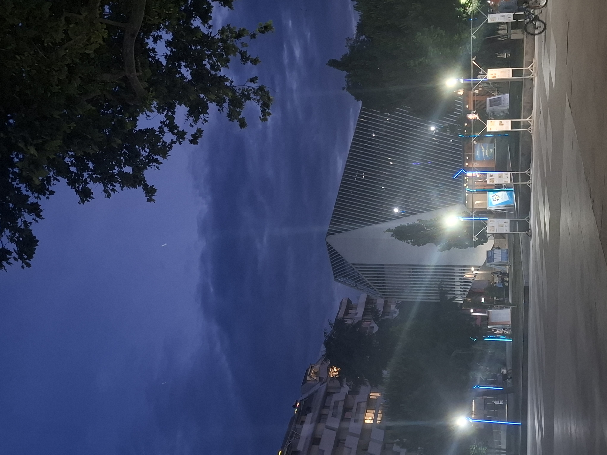 A city evening: streets, monuments, and a dimly lit cafe