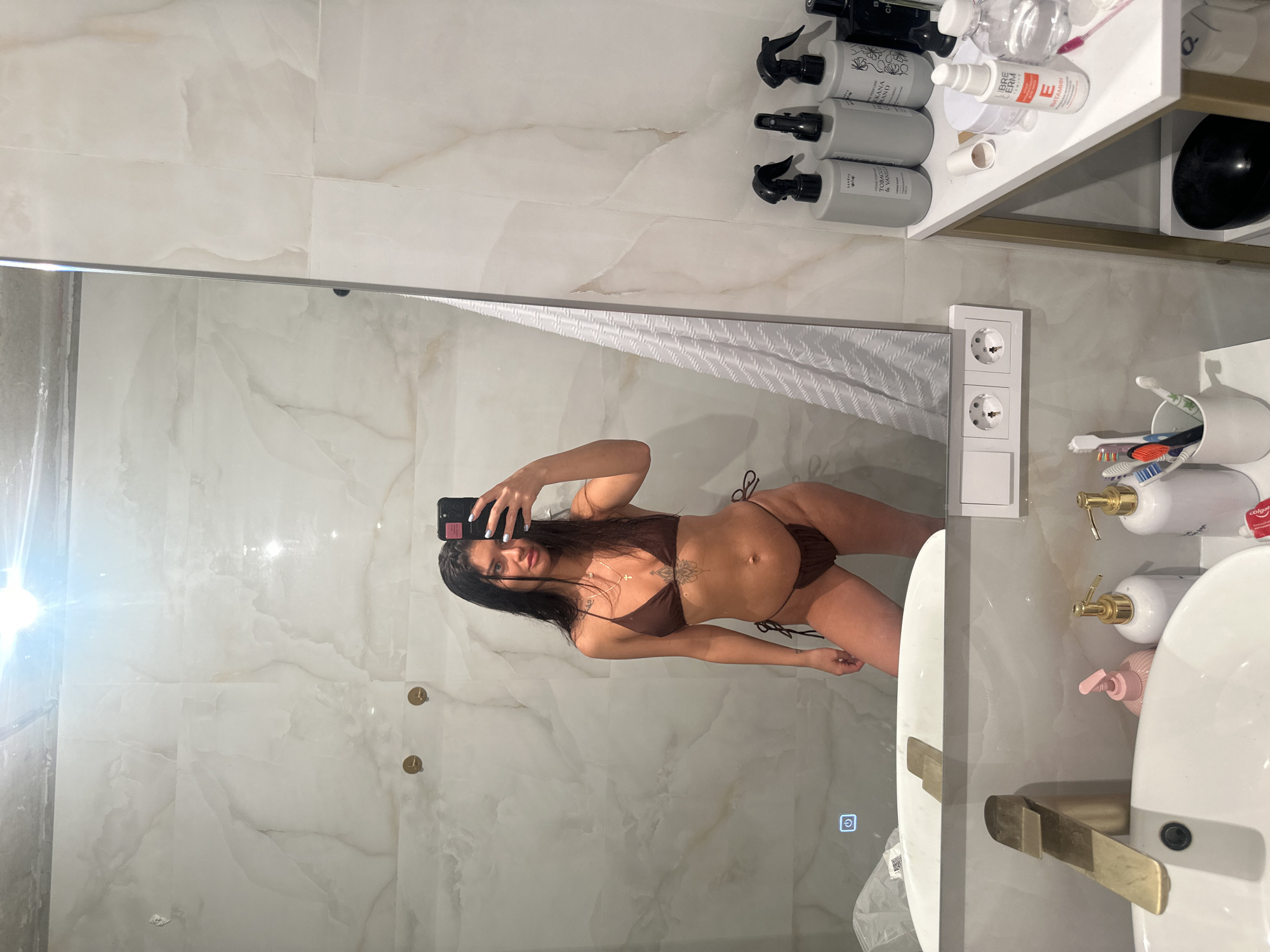Woman takes mirror selfie in Moscow bathroom