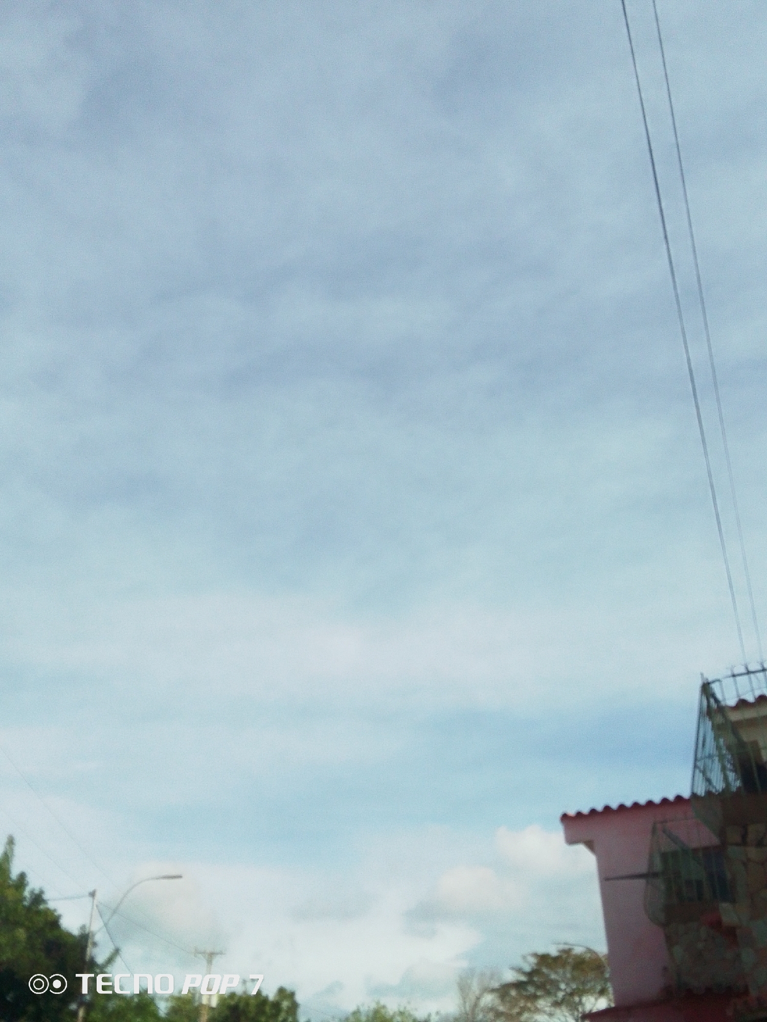 Evening sky with power lines over Altagracia residential area