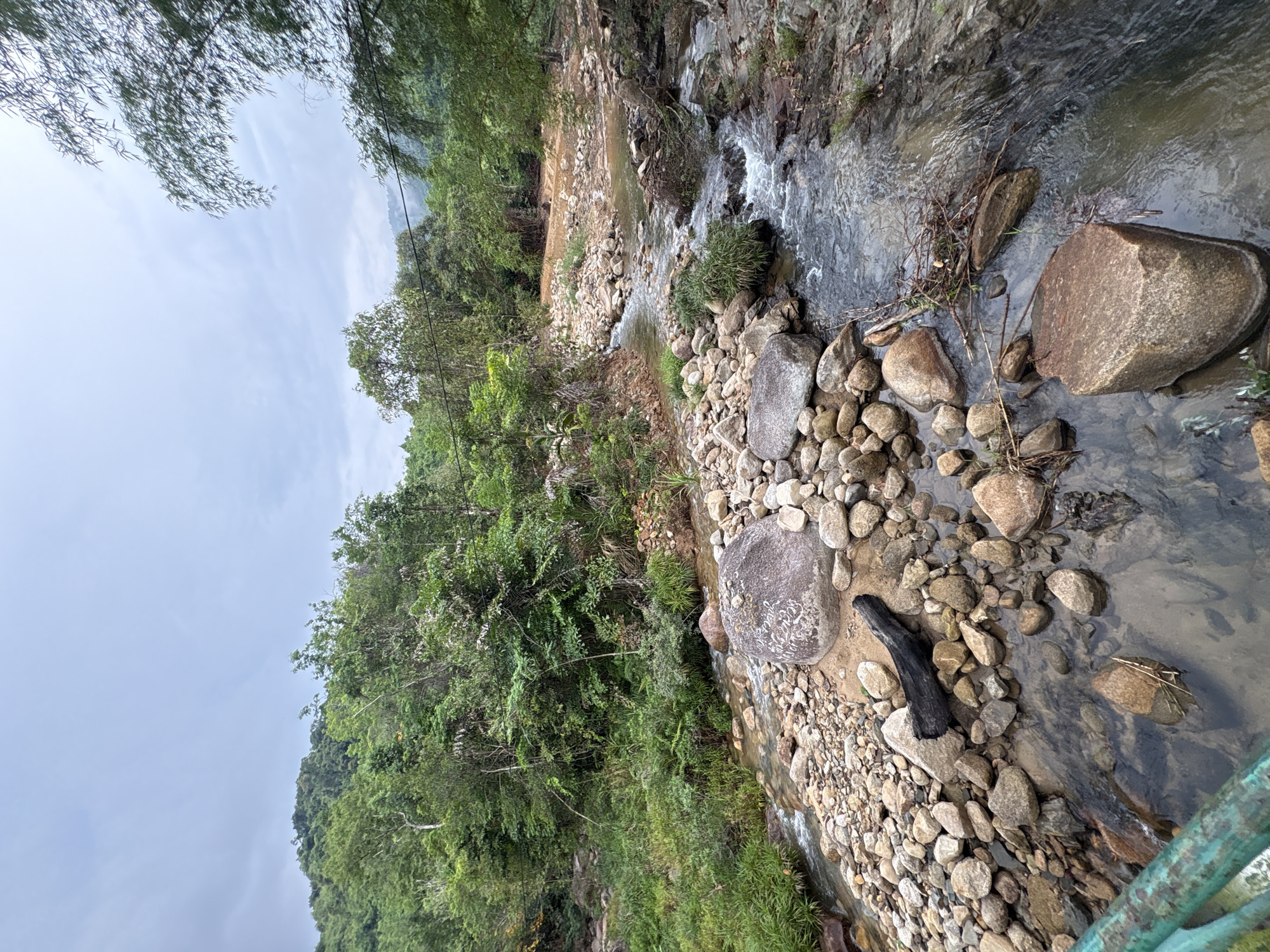 Rocky stream and suspension bridge documented in Khanh Vinh