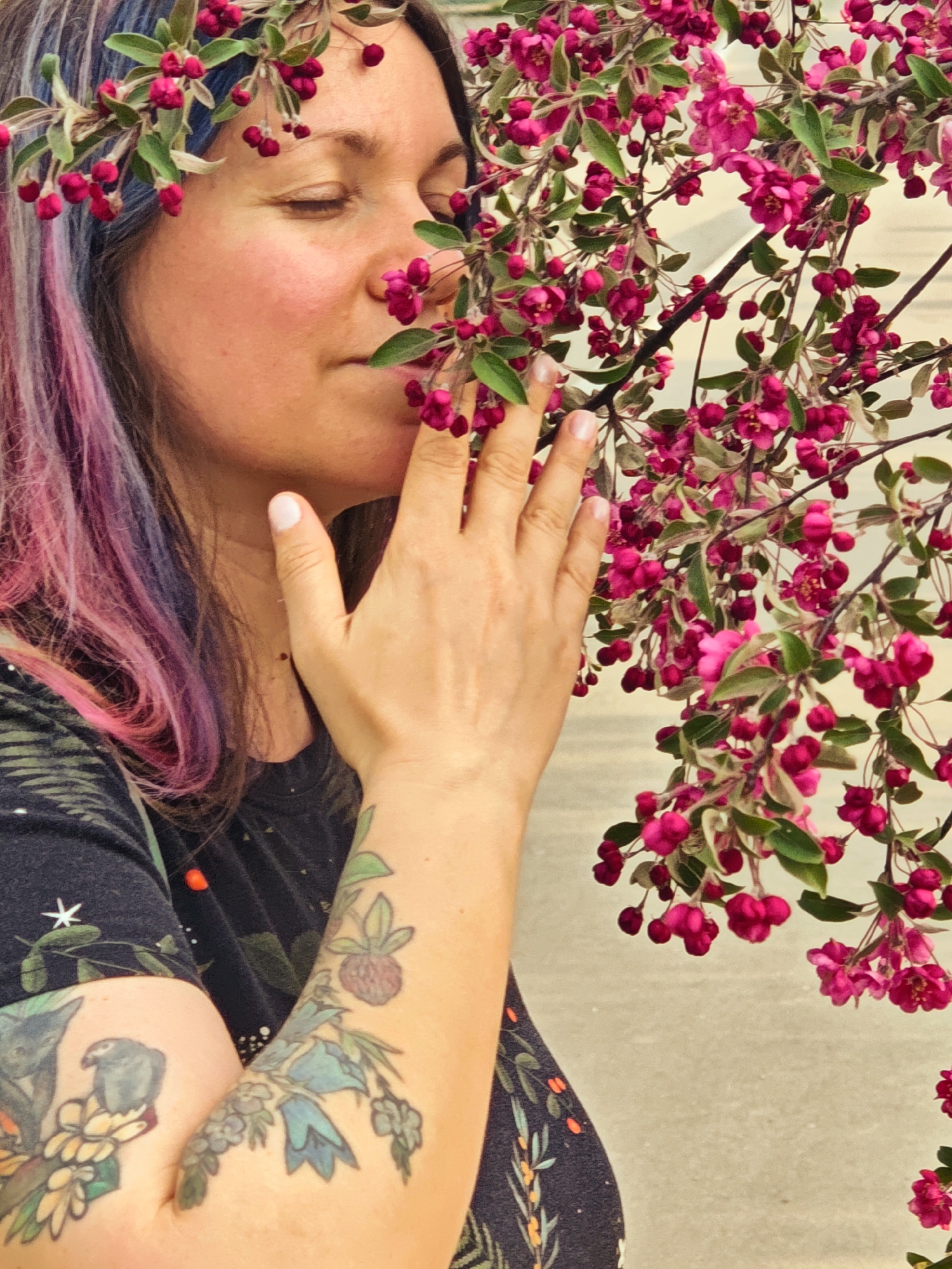 Woman enjoys spring blossoms in garden with stone heart