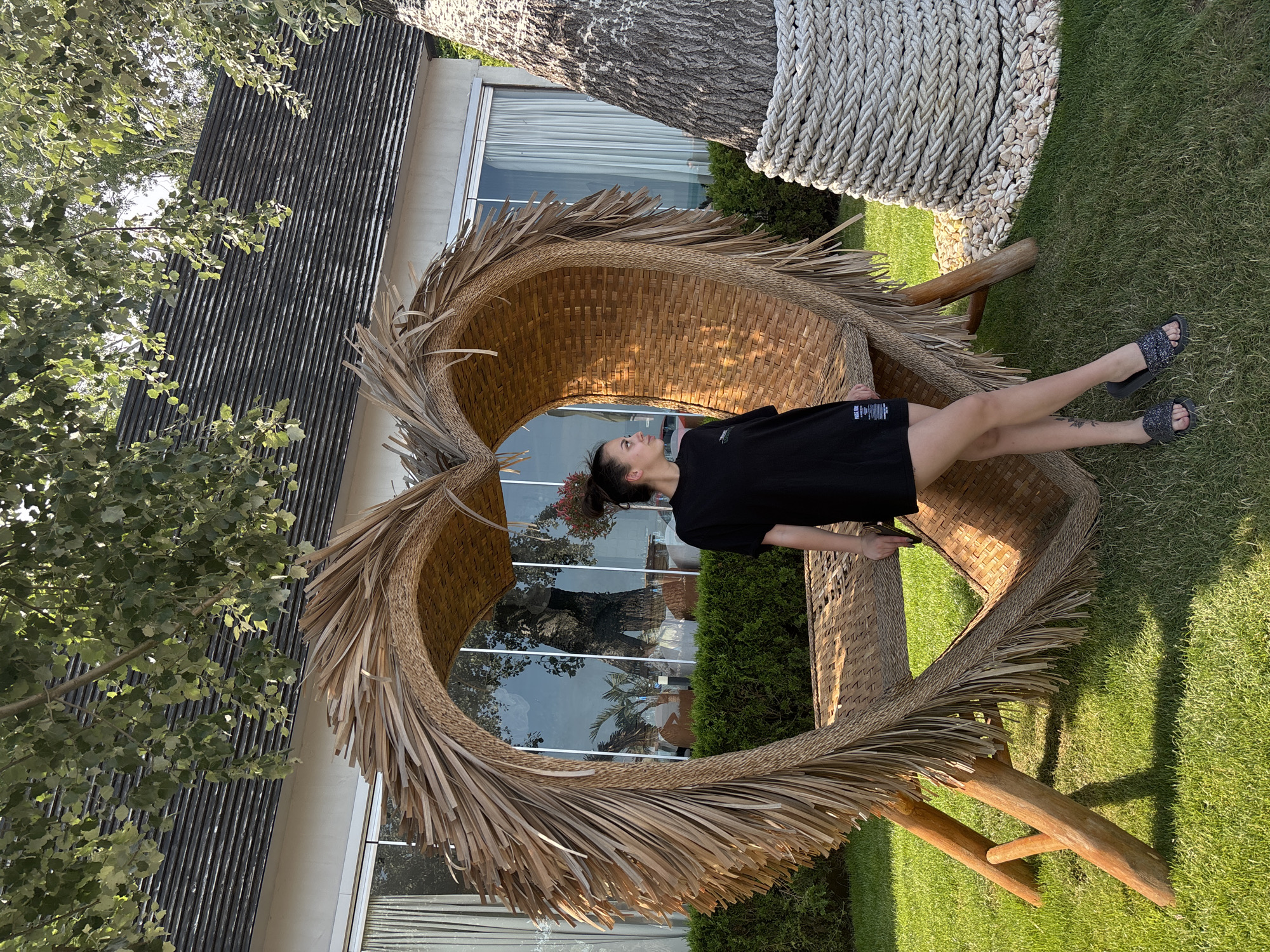 Woman poses with heart-shaped chair in Varna garden