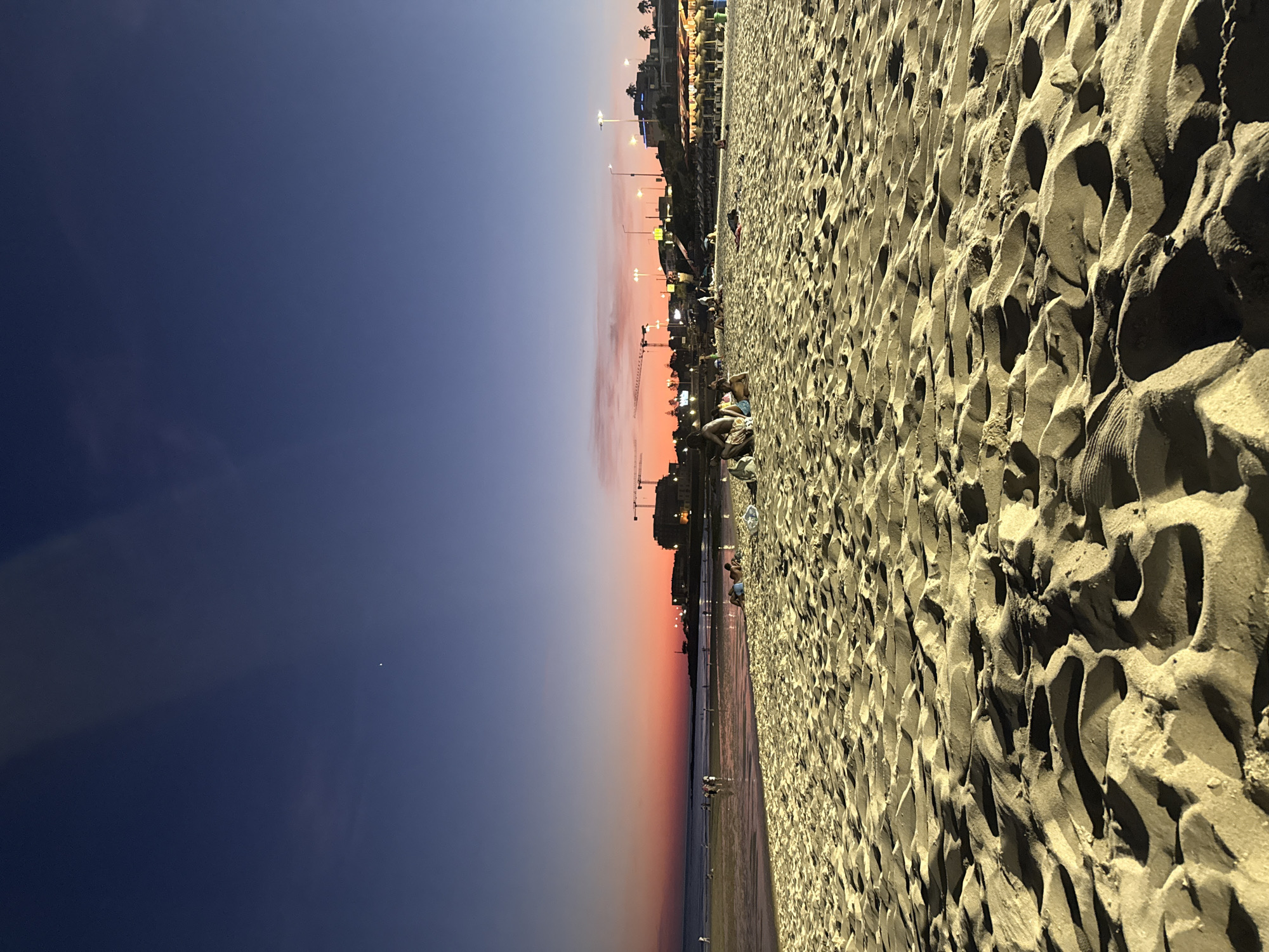 Cascais beach at twilight, sky fading orange and pink
