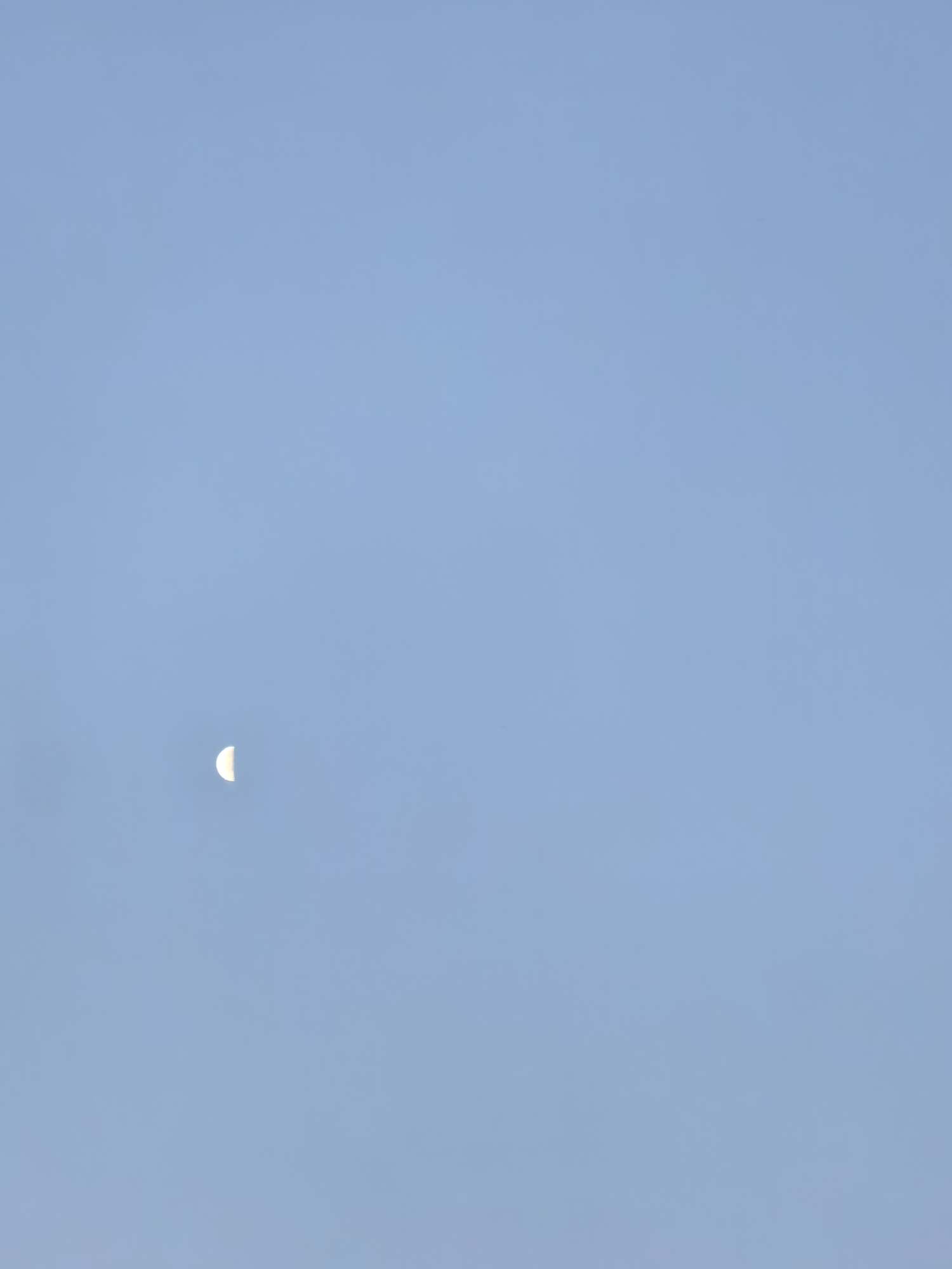 Crescent moon and shifting skies around sunset