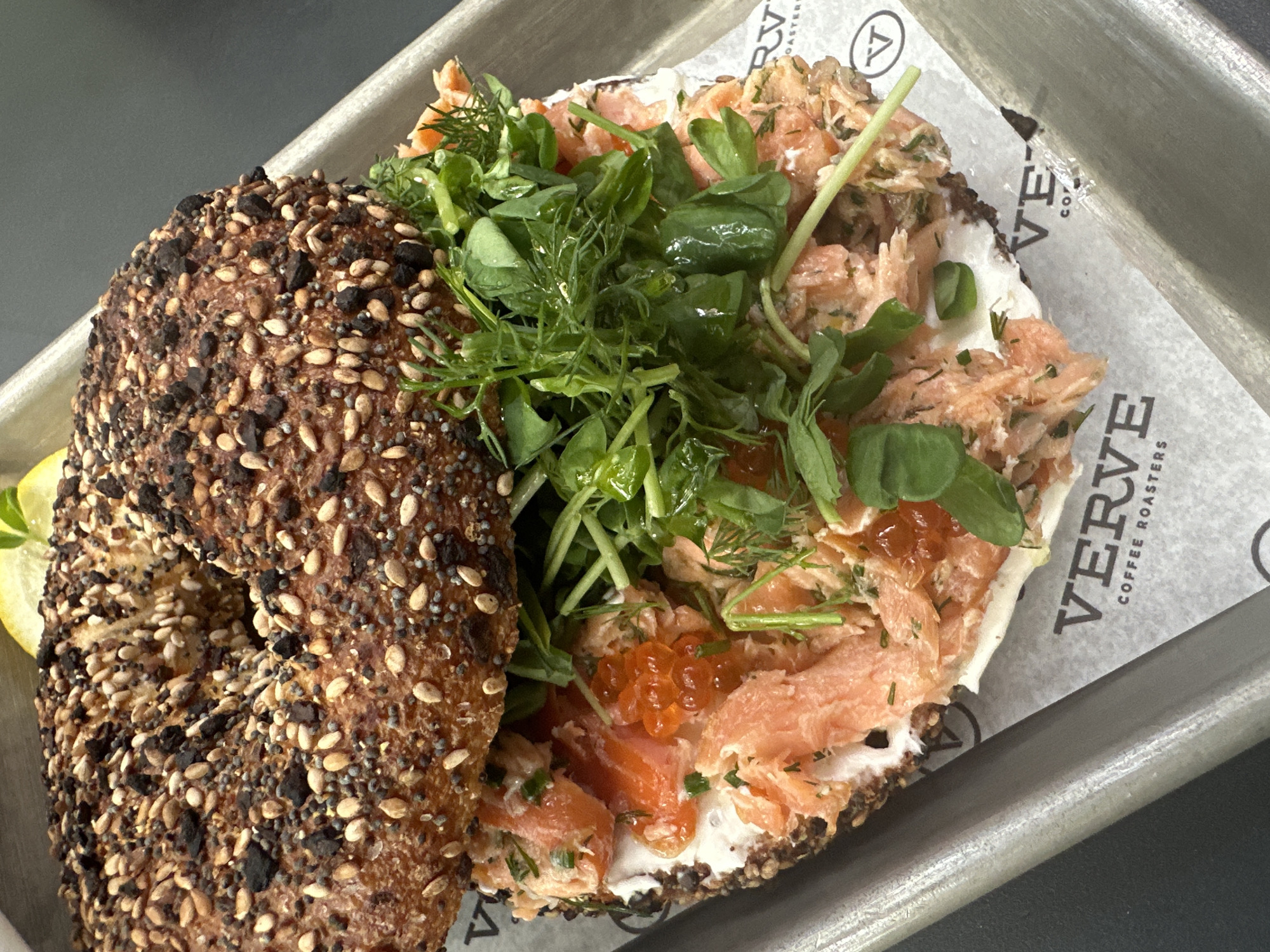 Gourmet seed bagel documented on metal tray
