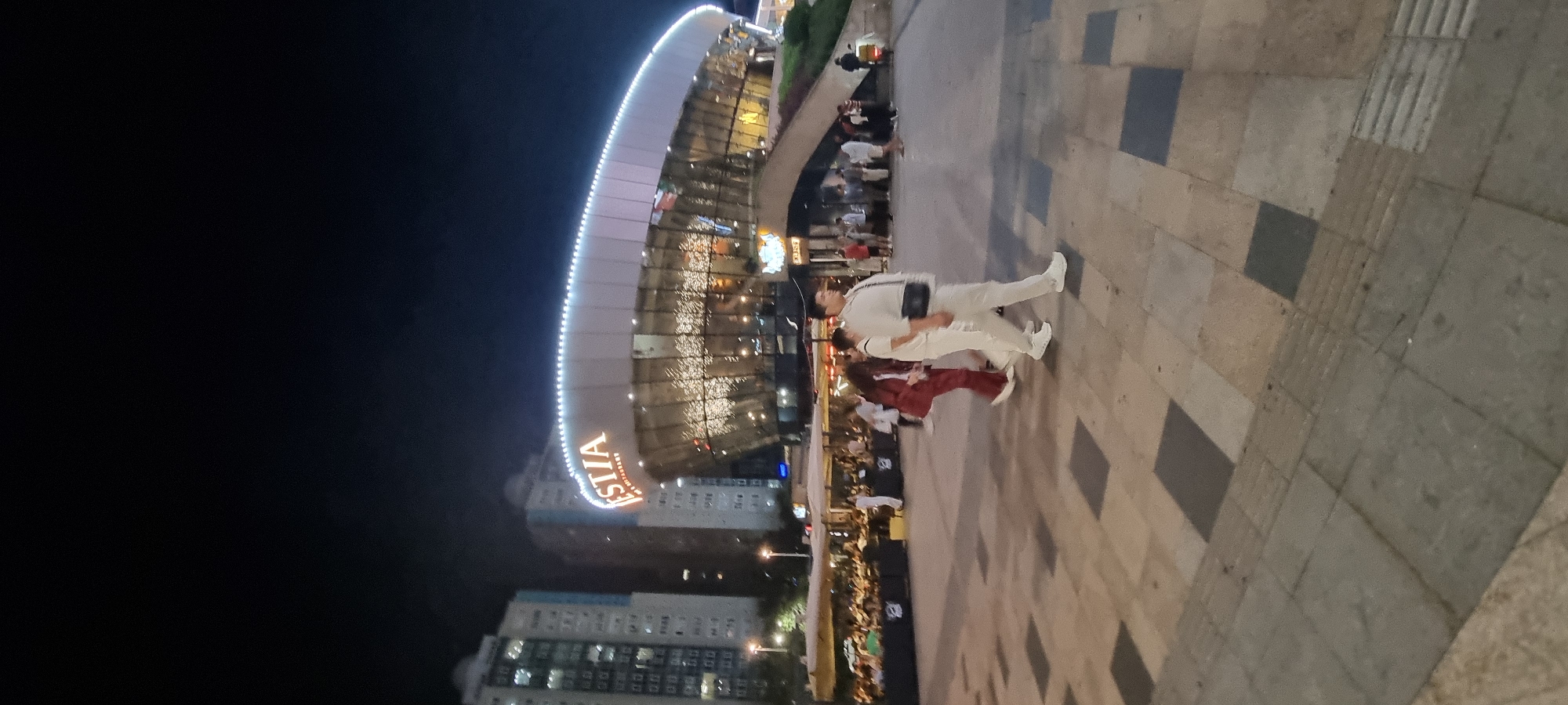 Almaty at night: lit facades and neon signs downtown