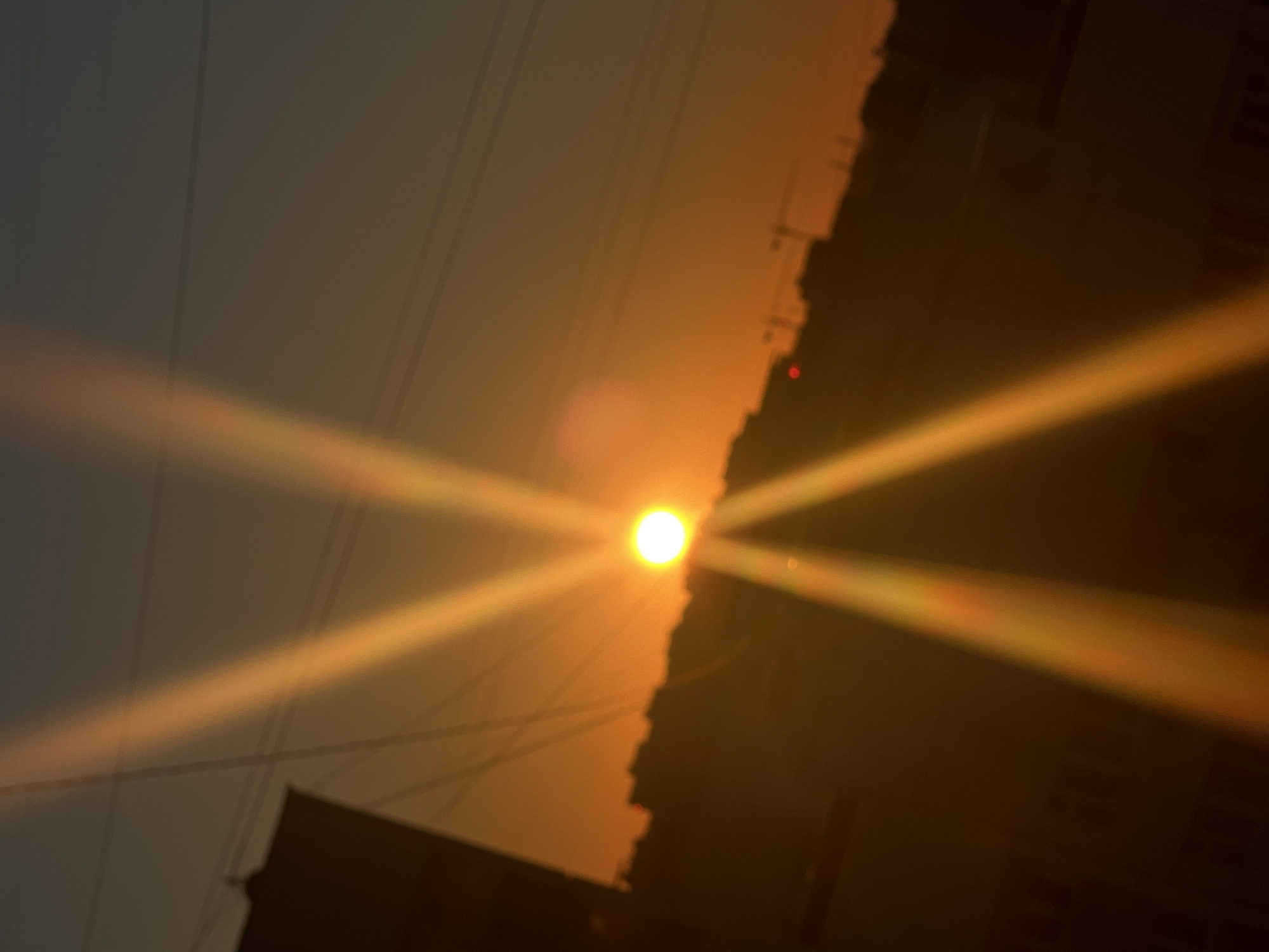 Moscow skyline glowing under a low, flaring sun