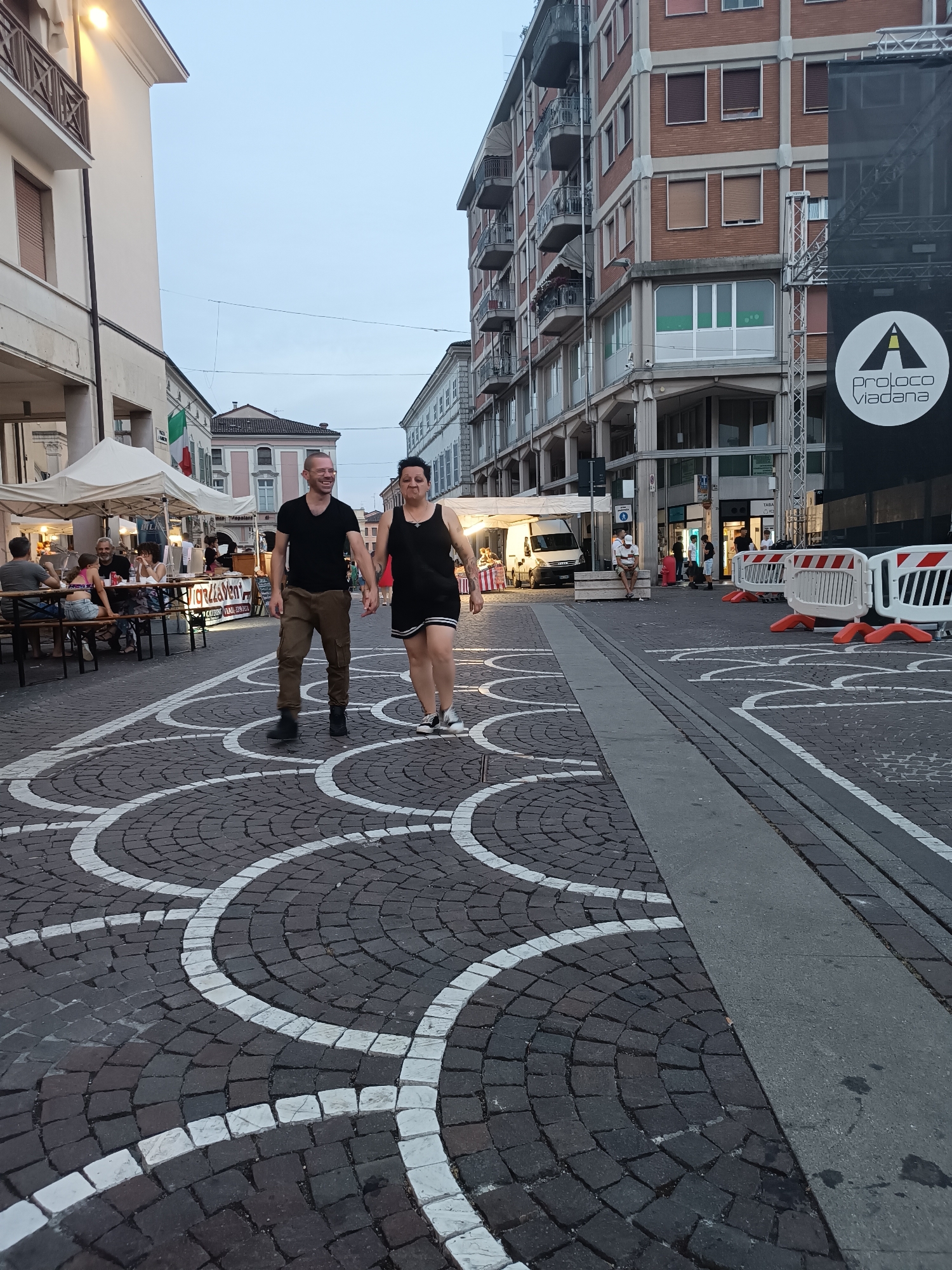Viadana's town center buzzes during a lively summer evening event.