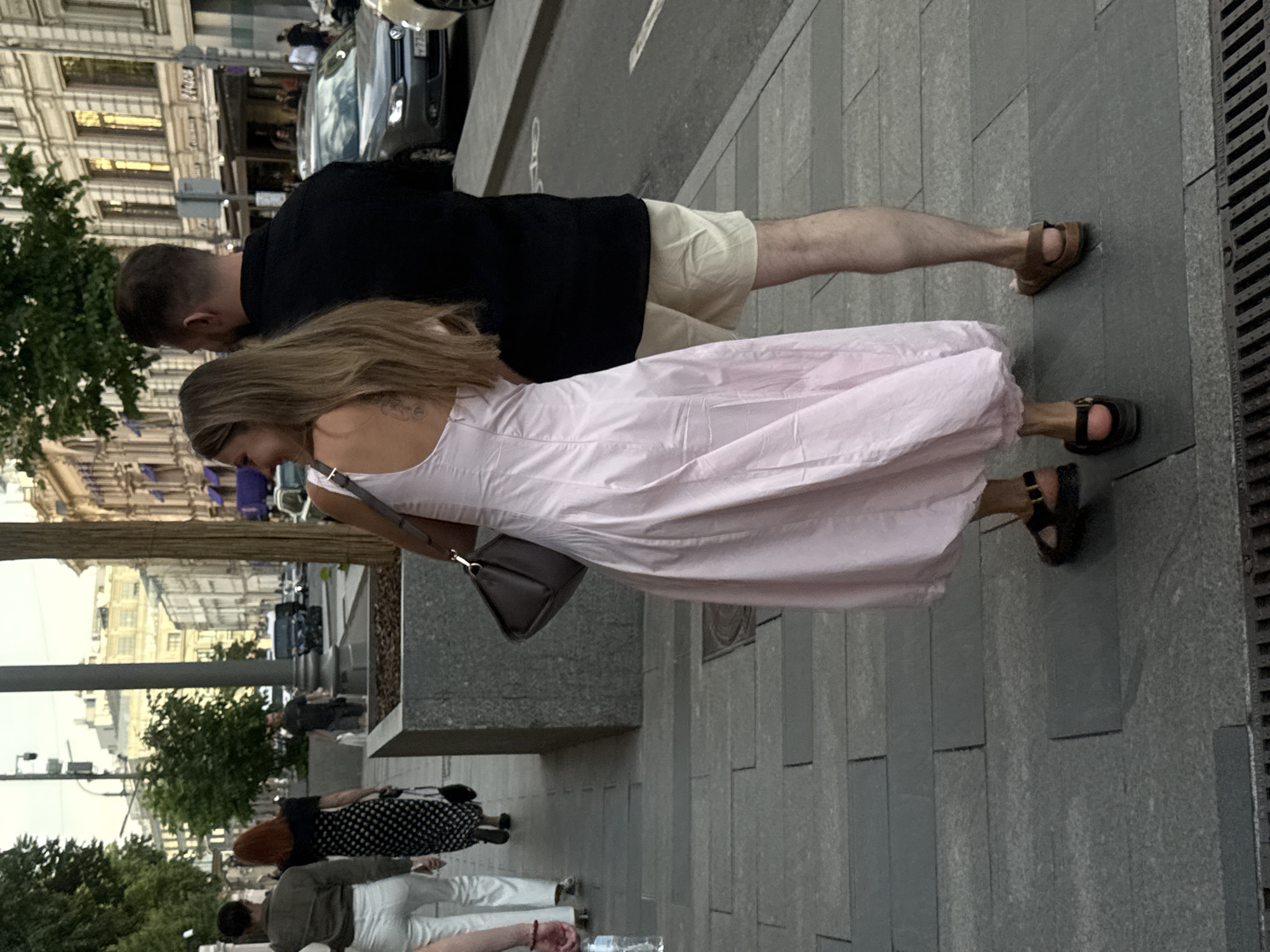 Moscow street life documented with performers, pedestrians, luxury car