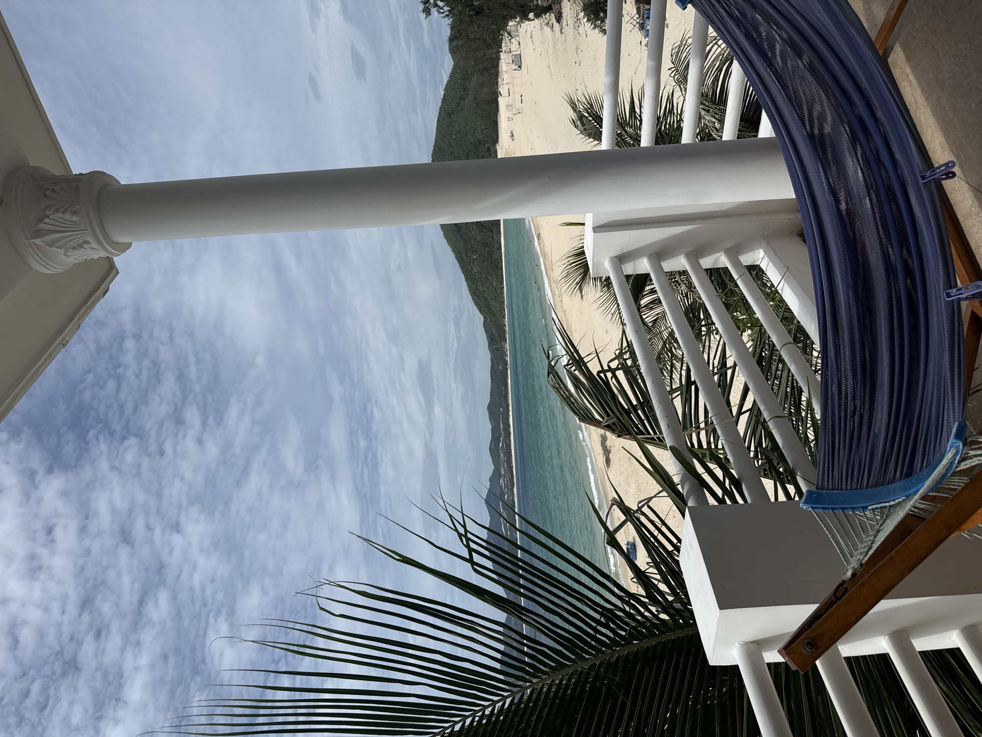 Calm tropical beach and coastline from shore and balcony
