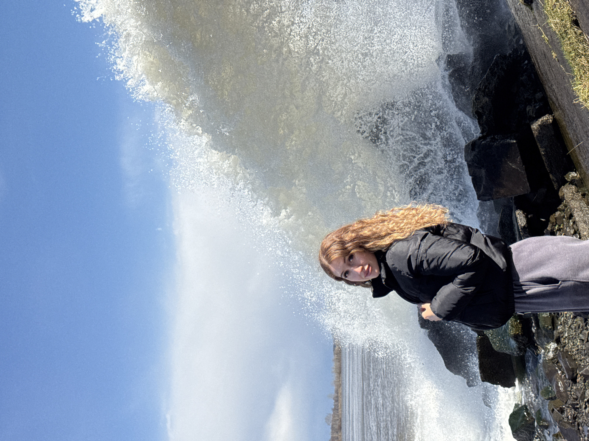 Woman visits waterfall spillway in Chernushka, Russia
