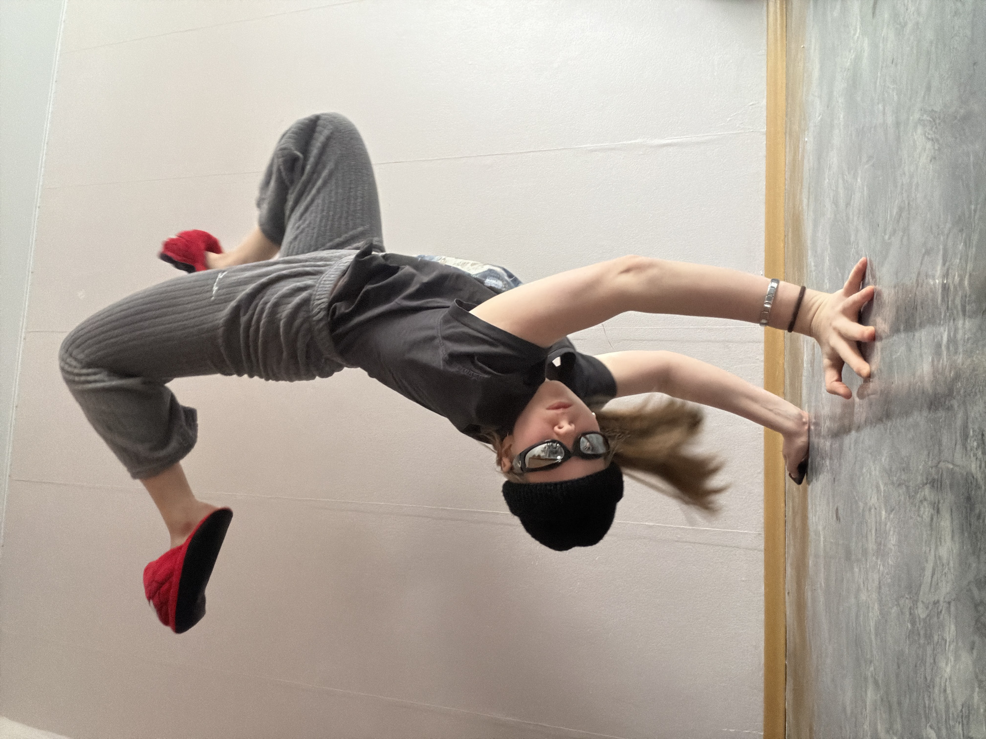 Young person performs handstands and acrobatics indoors in Perm