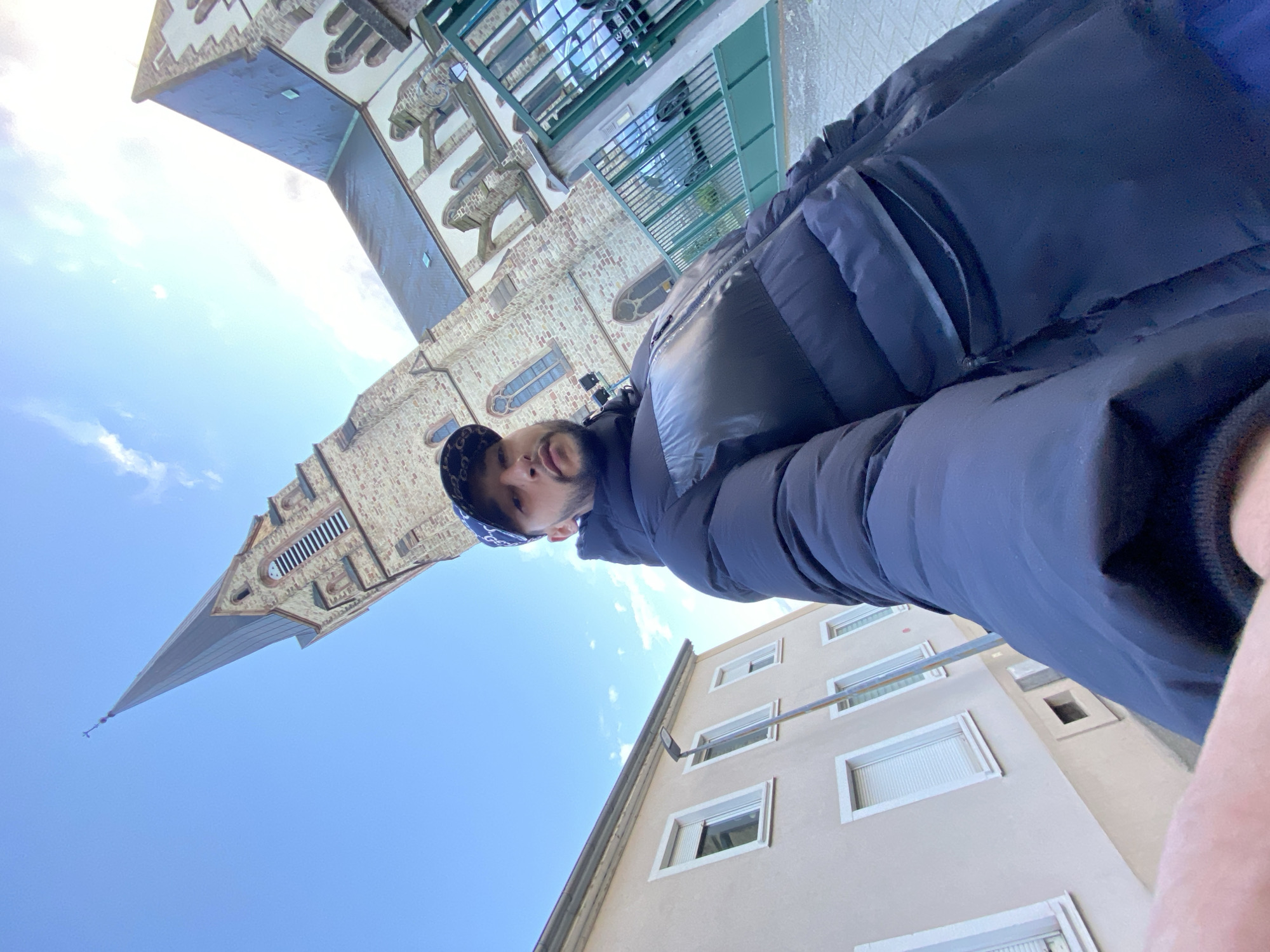 Person photographed walking through Bischheim streets near historic church