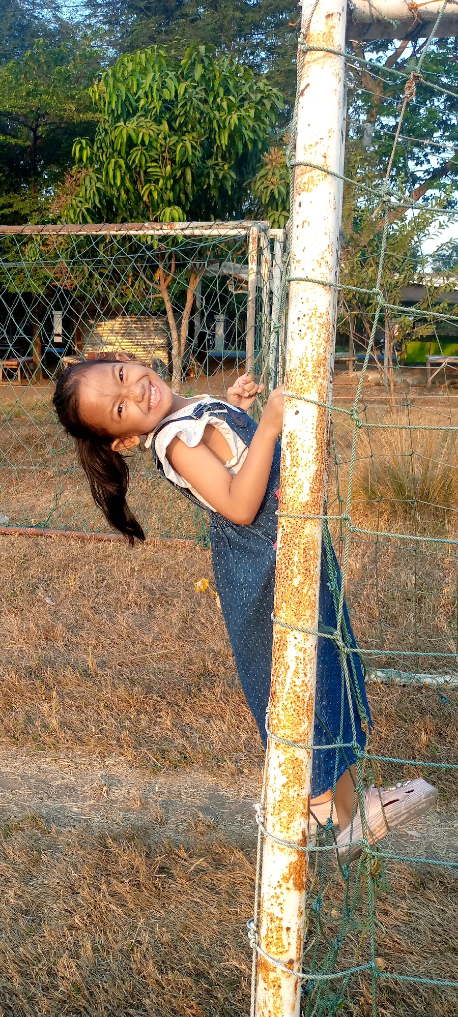 Kids hanging around a scrappy football pitch in Pacing, Indonesia