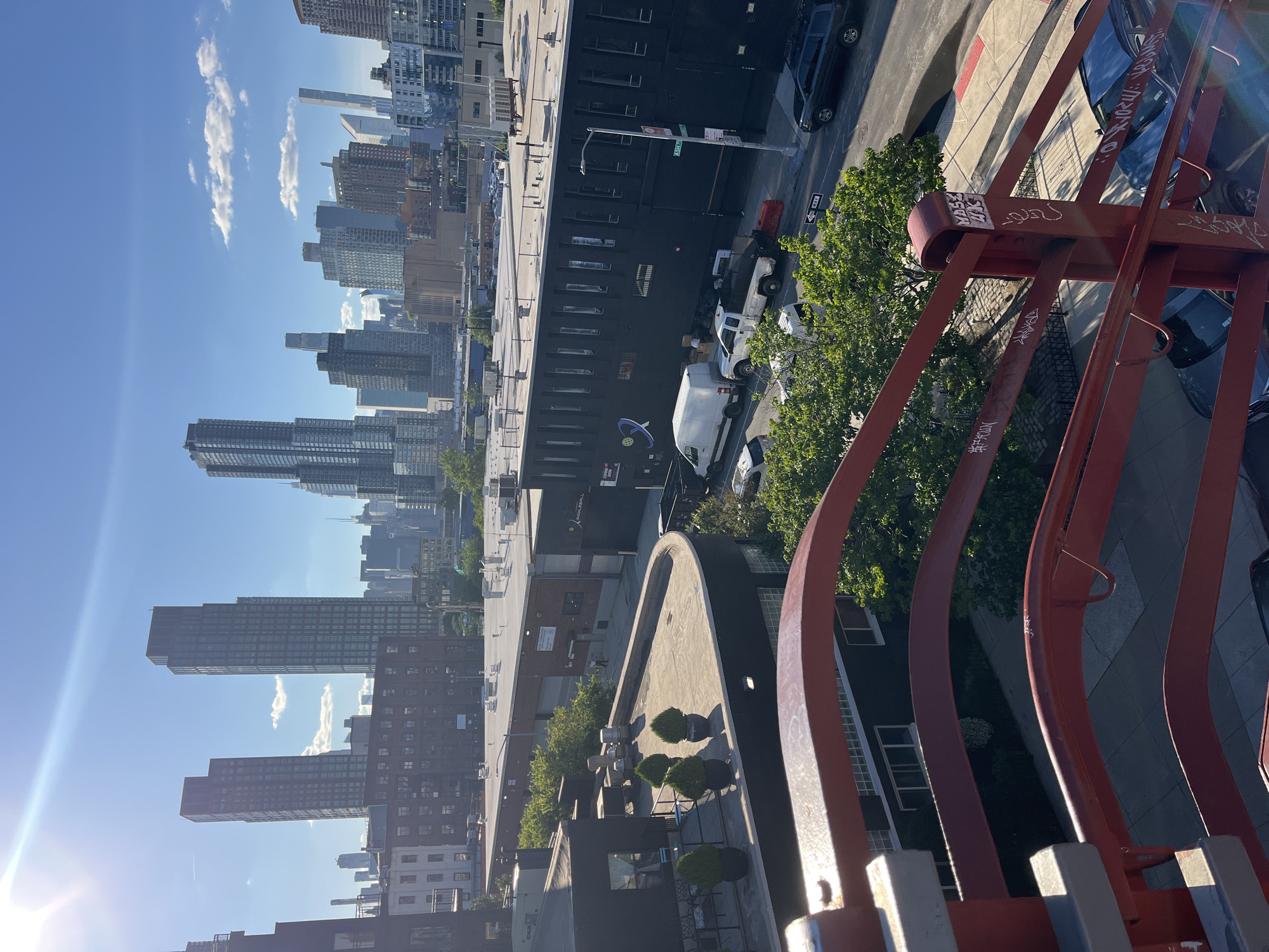 Cyclists gather on a NYC drawbridge with skyline views