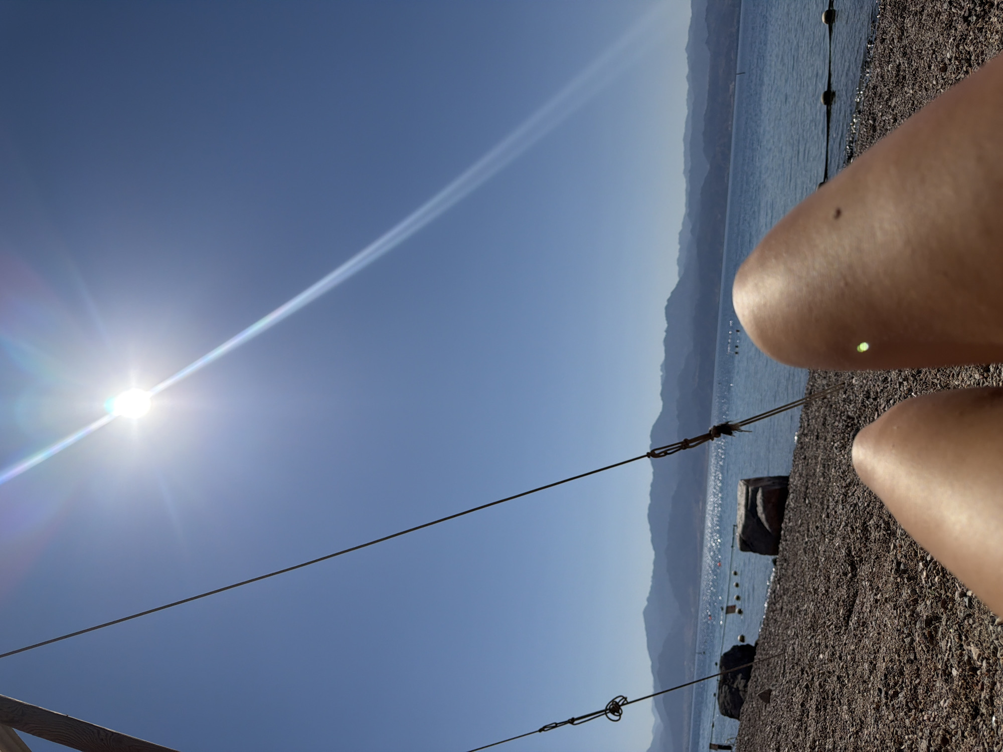 Sunny morning downtime on Eilat's pebble beach by the Red Sea