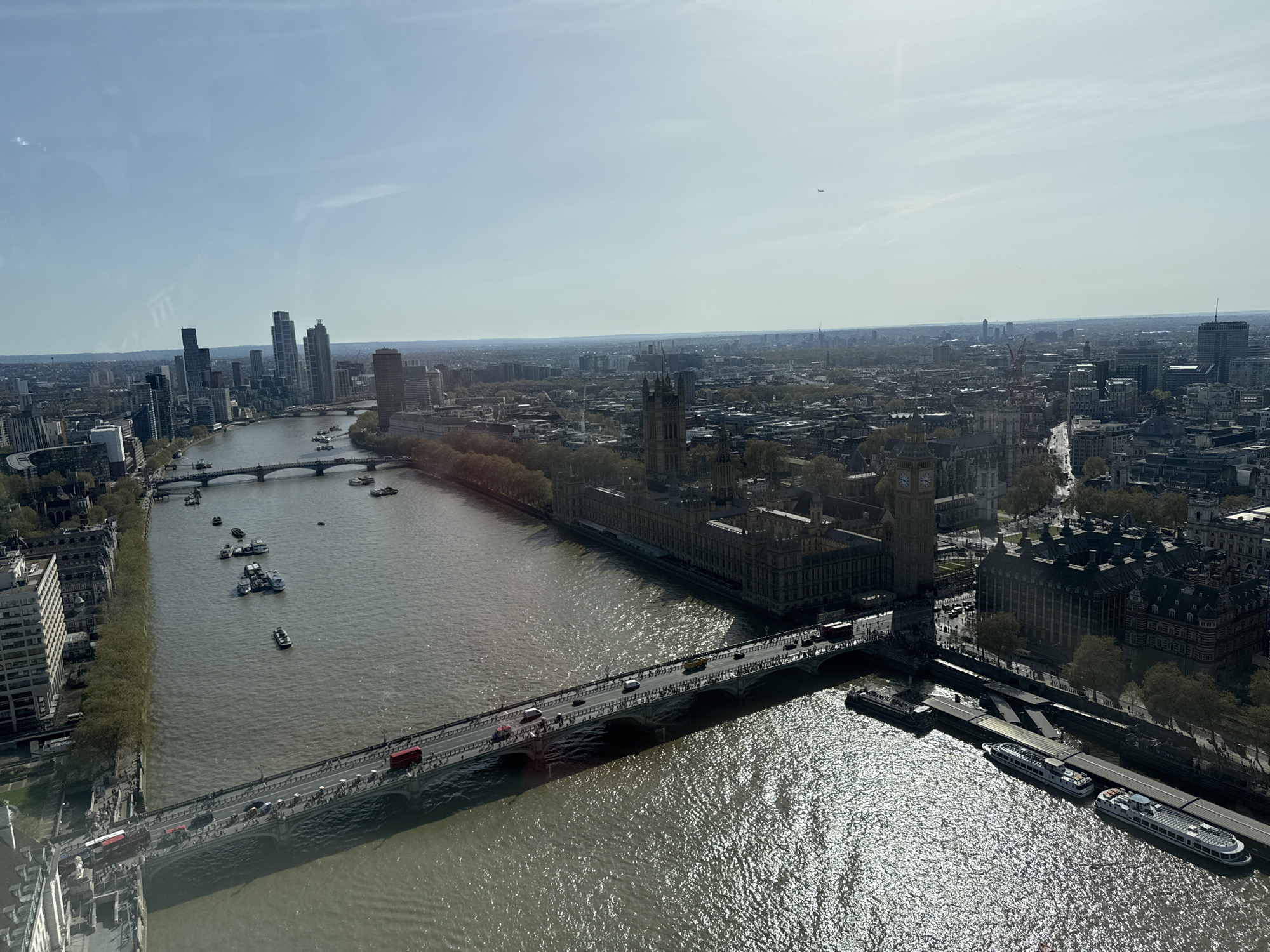 Tourist photographs London's Big Ben and Westminster landmarks