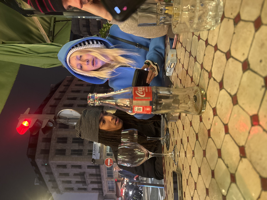 Young adults gather for evening drinks at Paris café