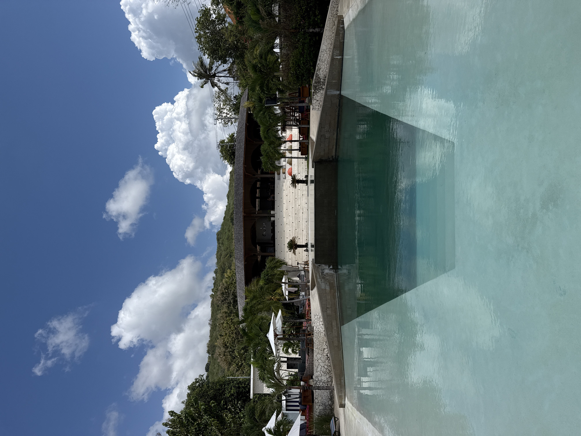 Resort pool and beach swing scene in Nusa Penida