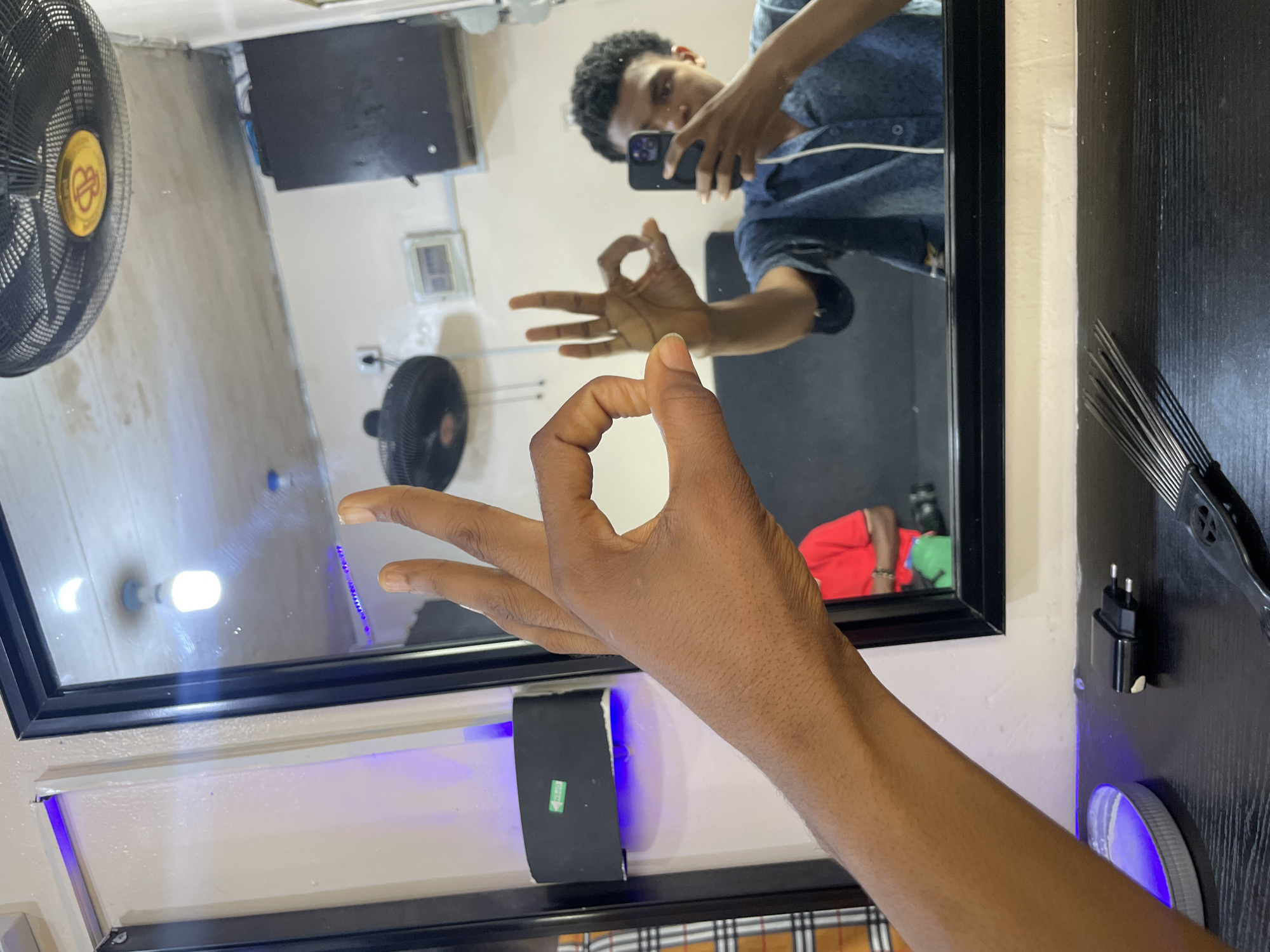 Barber shop visit documented through selfies in Ado, Nigeria