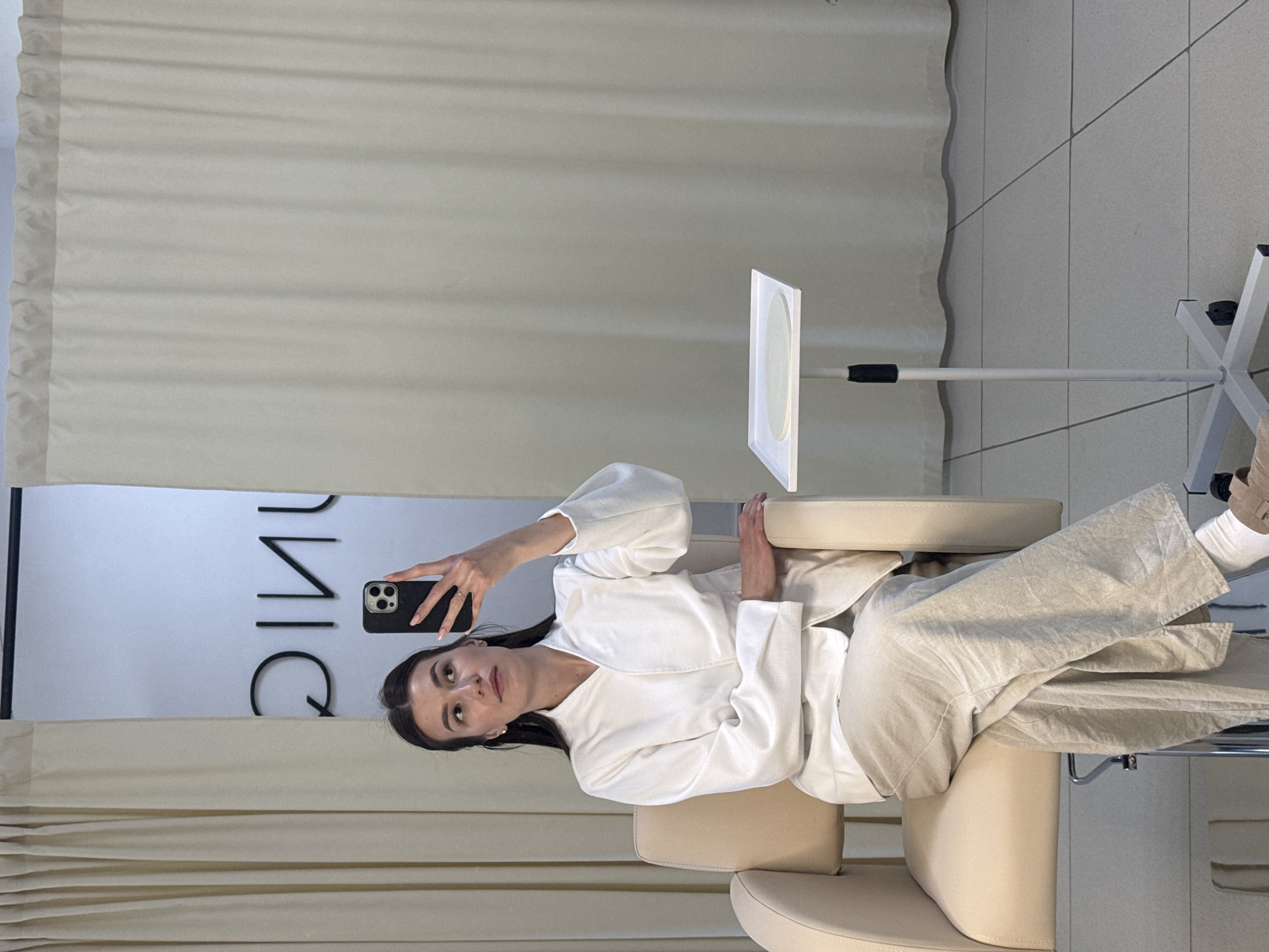 Woman takes selfie in salon chair in Chaikovsky