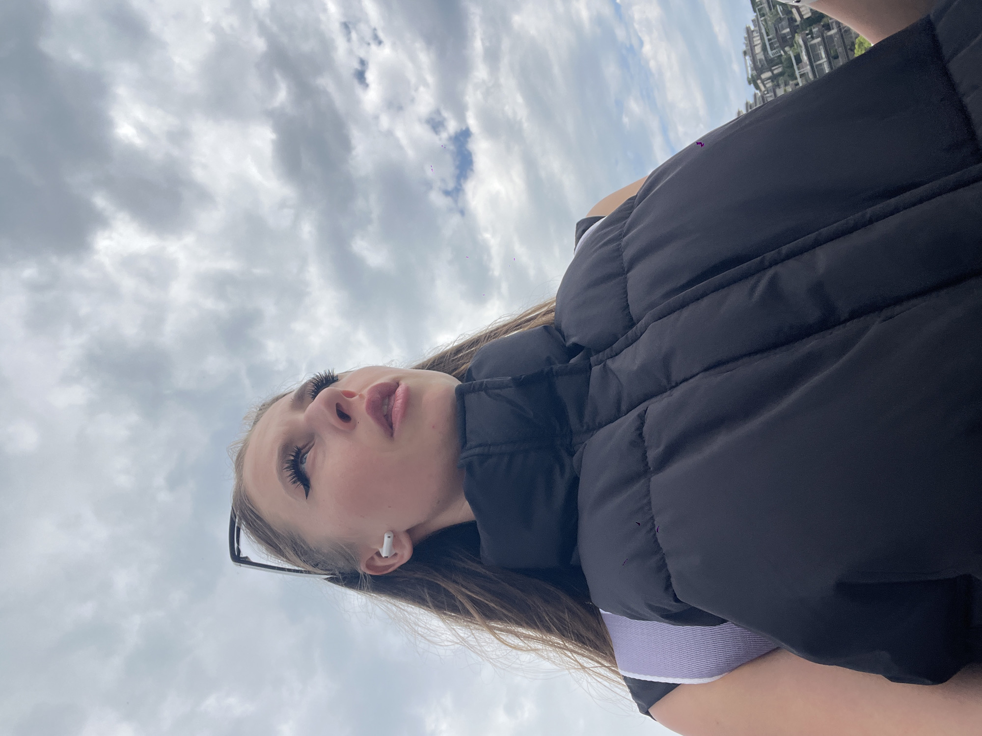 Woman photographed against cloudy skies in coastal Budva